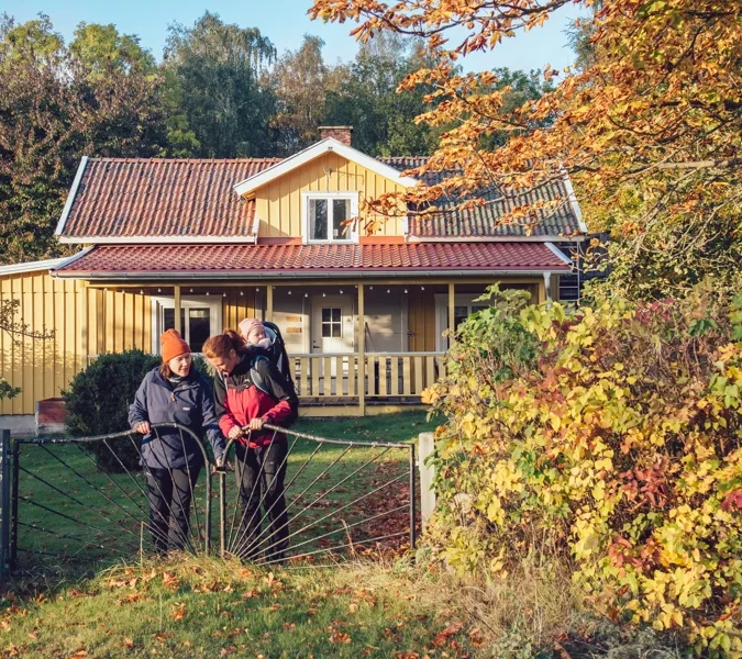 A group of people standing in front of a house.
