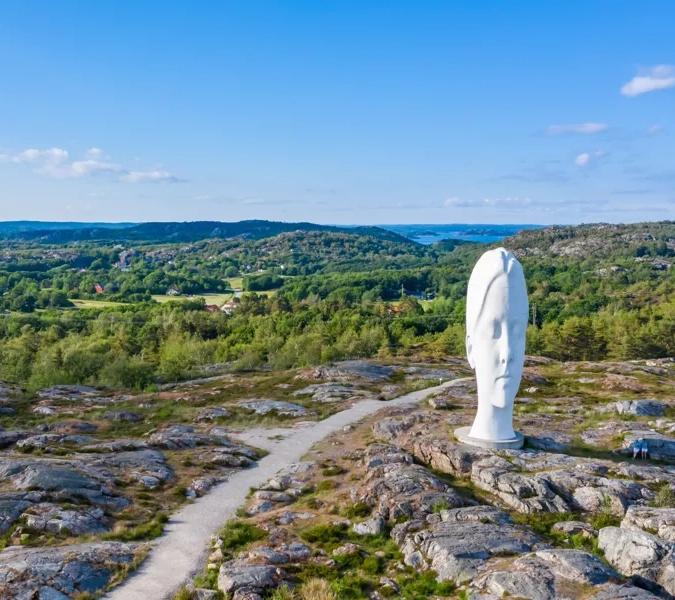 A statue of a person on top of a mountain.