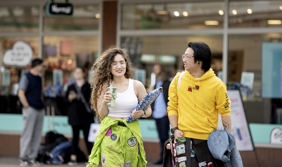 En man och en kvinna går längs en gata.