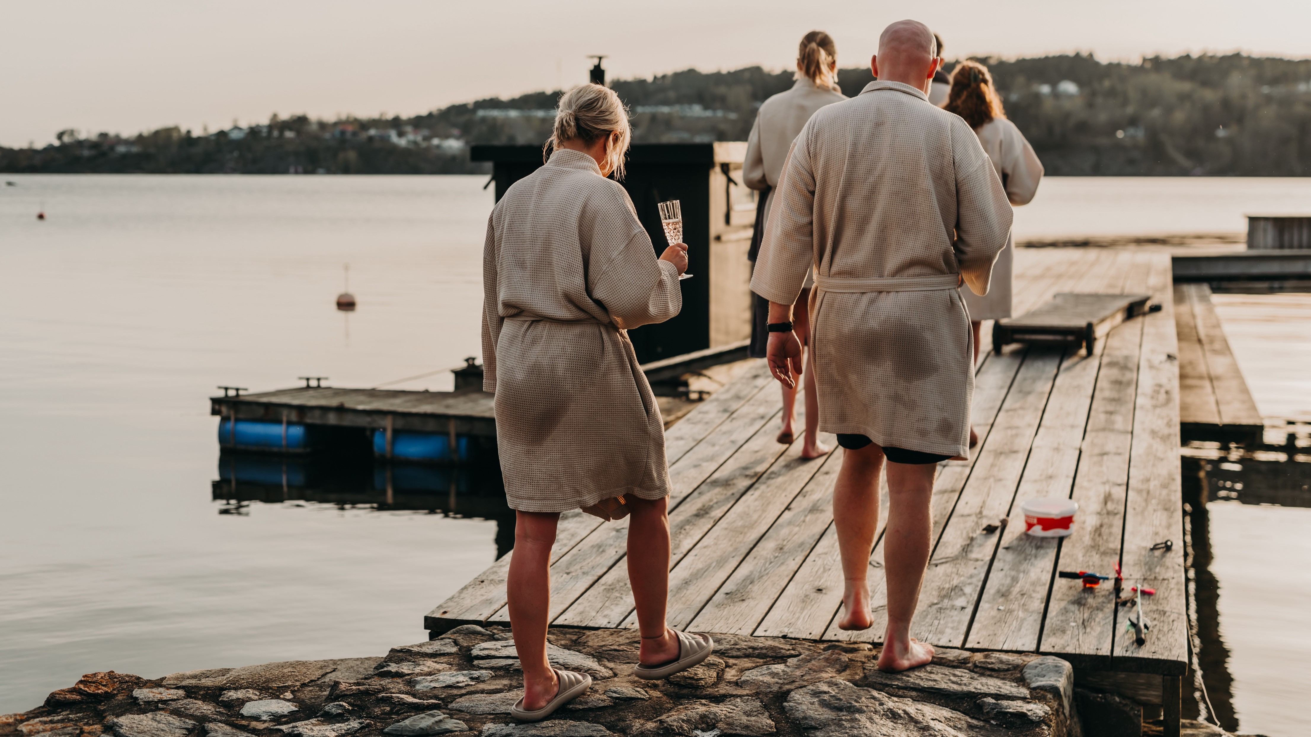 A group of people walking on a dock.
