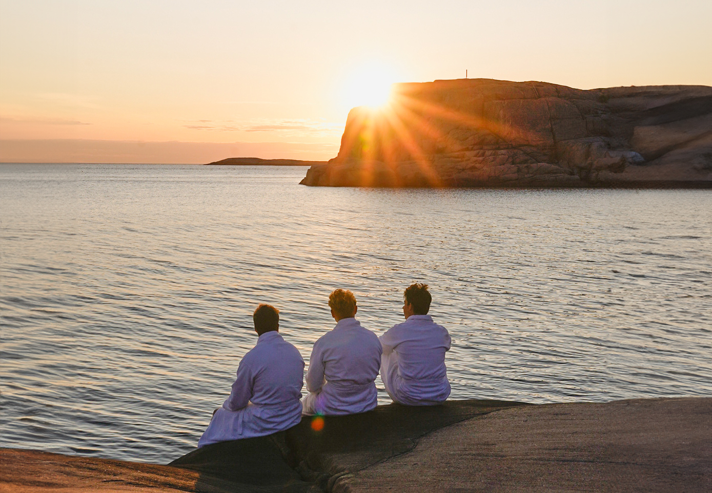 A group of guys, conference guests in bathrobes on a cliff and a sunset by the sea, Hotell Smögens Hafvsbad