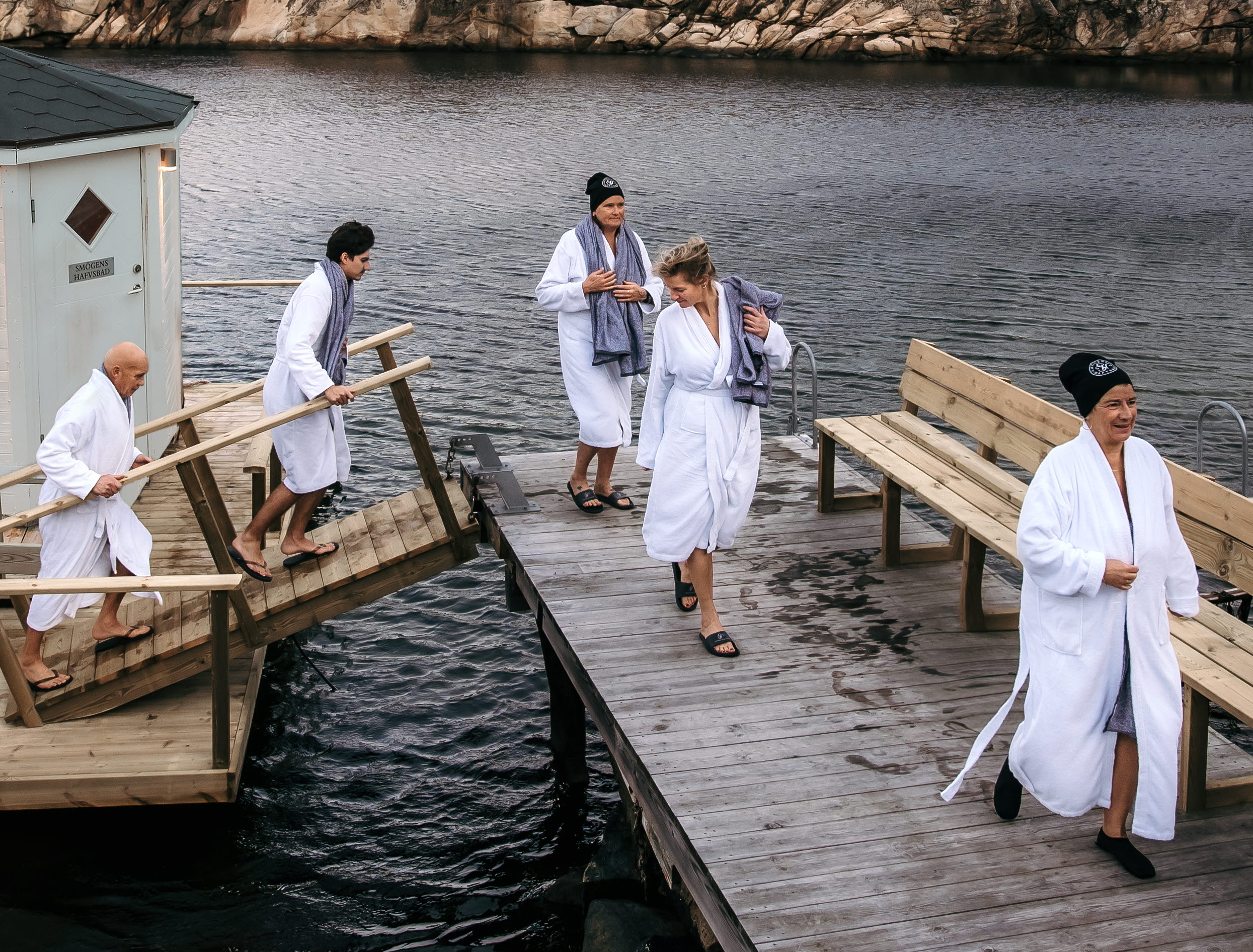 A group of women, conference guests in bathrobes on the jetty from the cold bathhouse at Hotel Smögens Hafvsbad