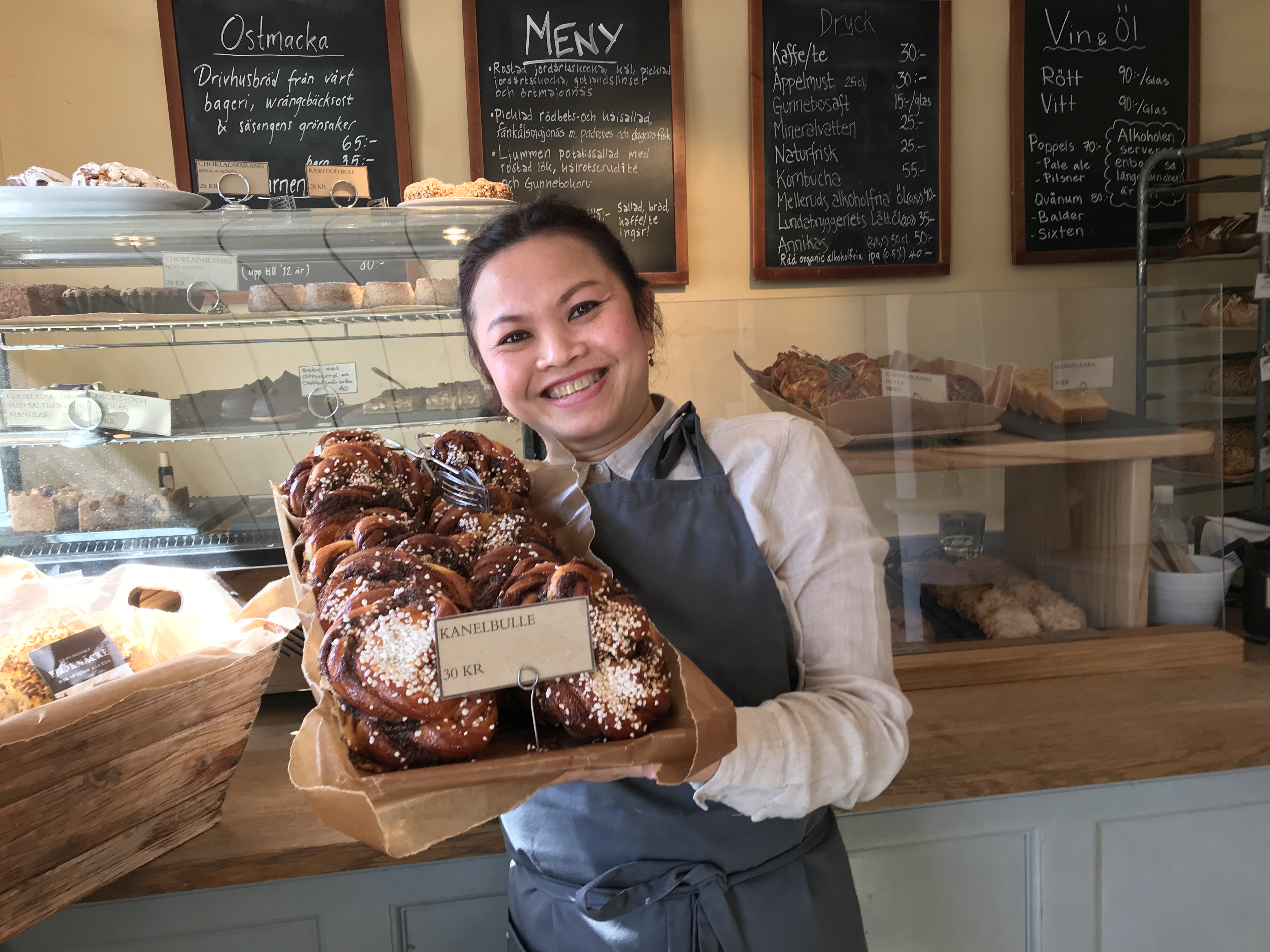 Woman holding fresh buns at Gunnebo Slott