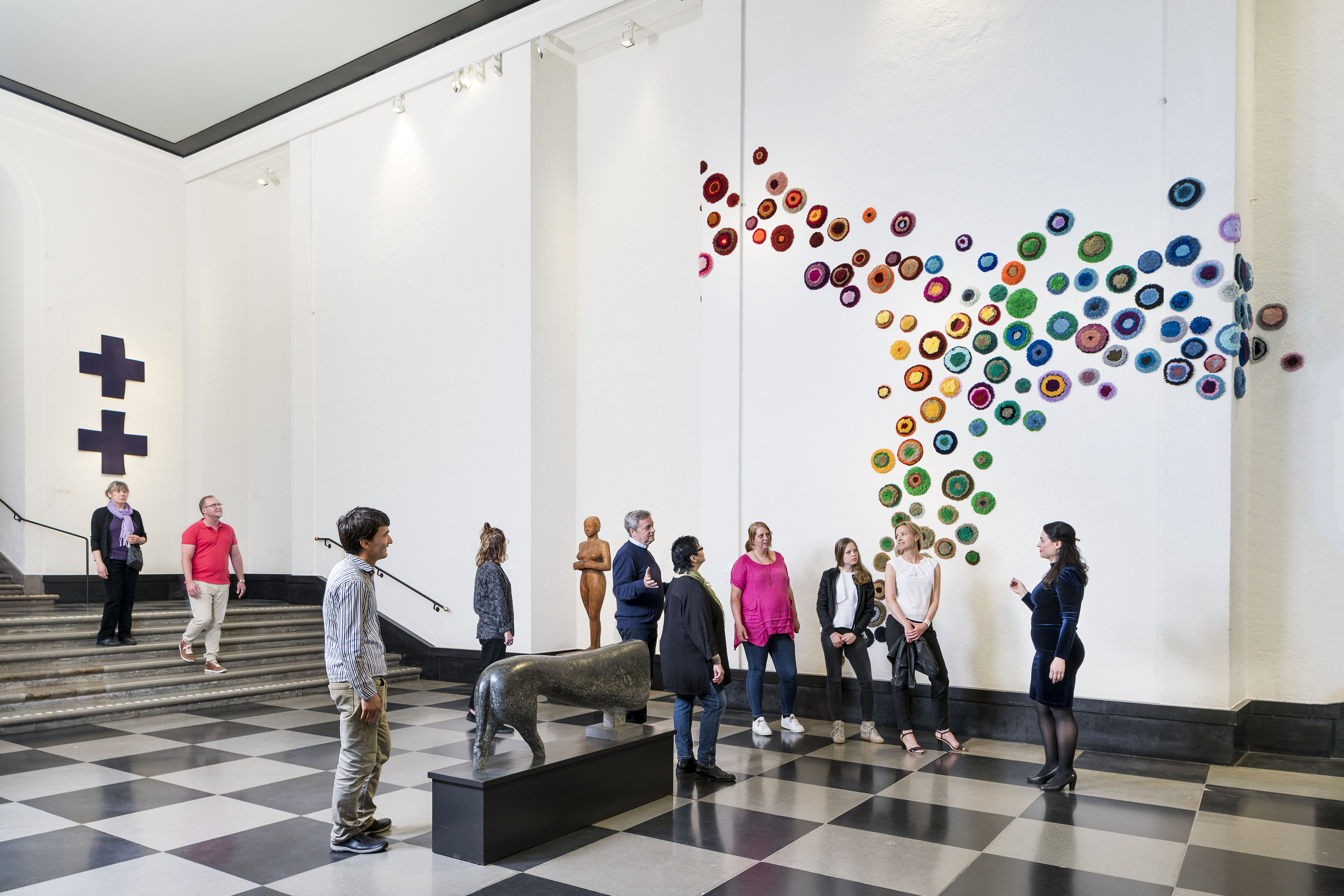 People looking at sculptures. 