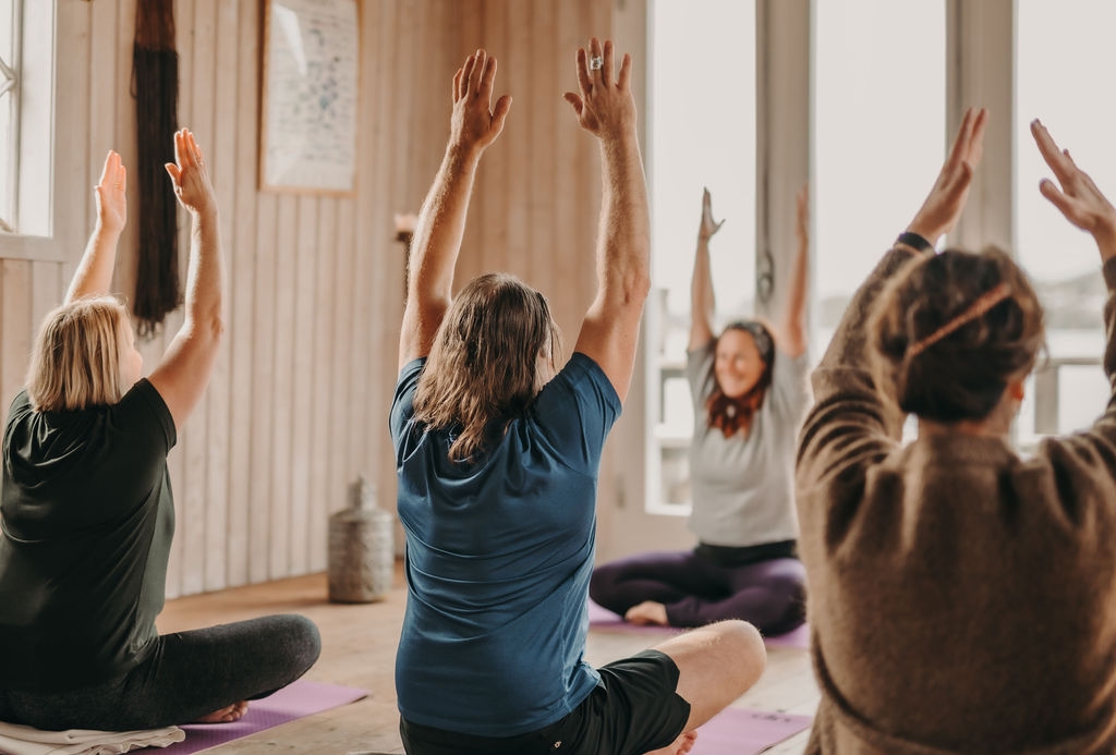 People doing yoga in a yoga studio.