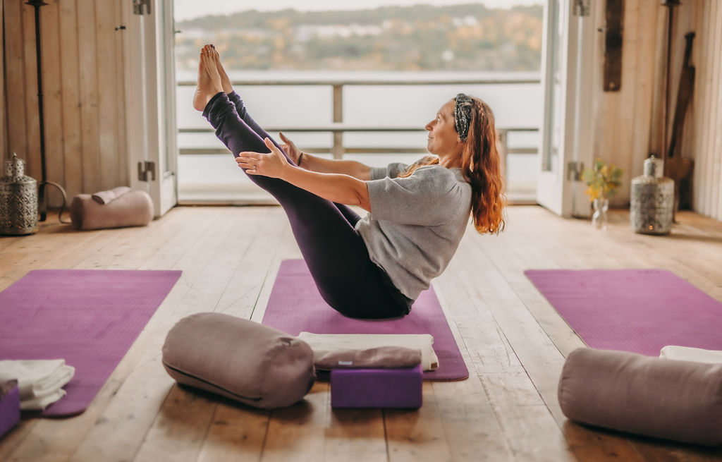 People doing yoga in a yoga studio.
