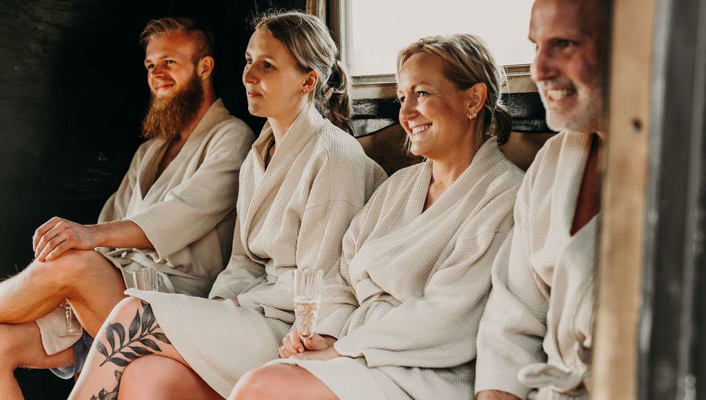 People in and around a sauna.