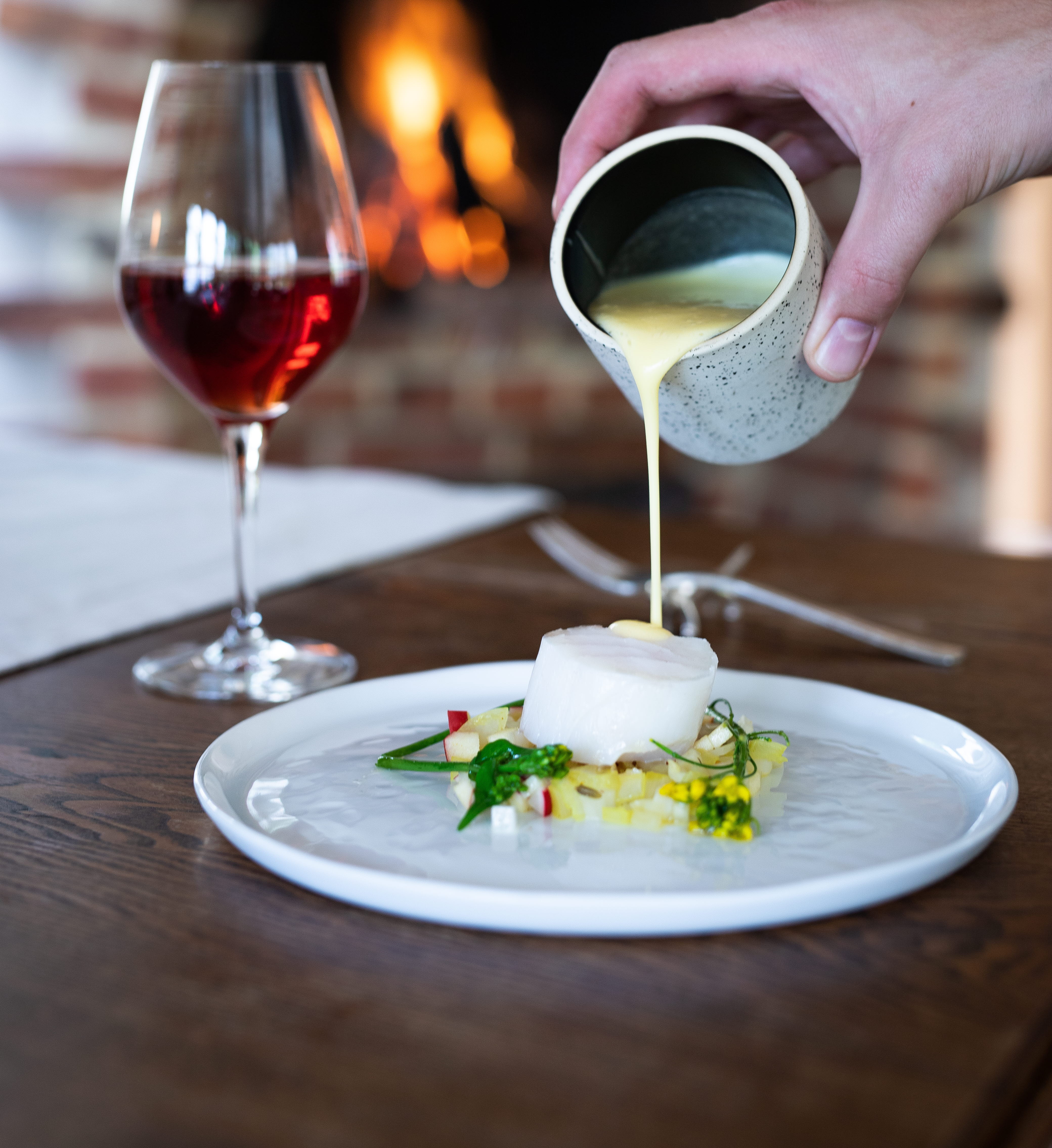 Plate with luxurious food and a glass of wine.