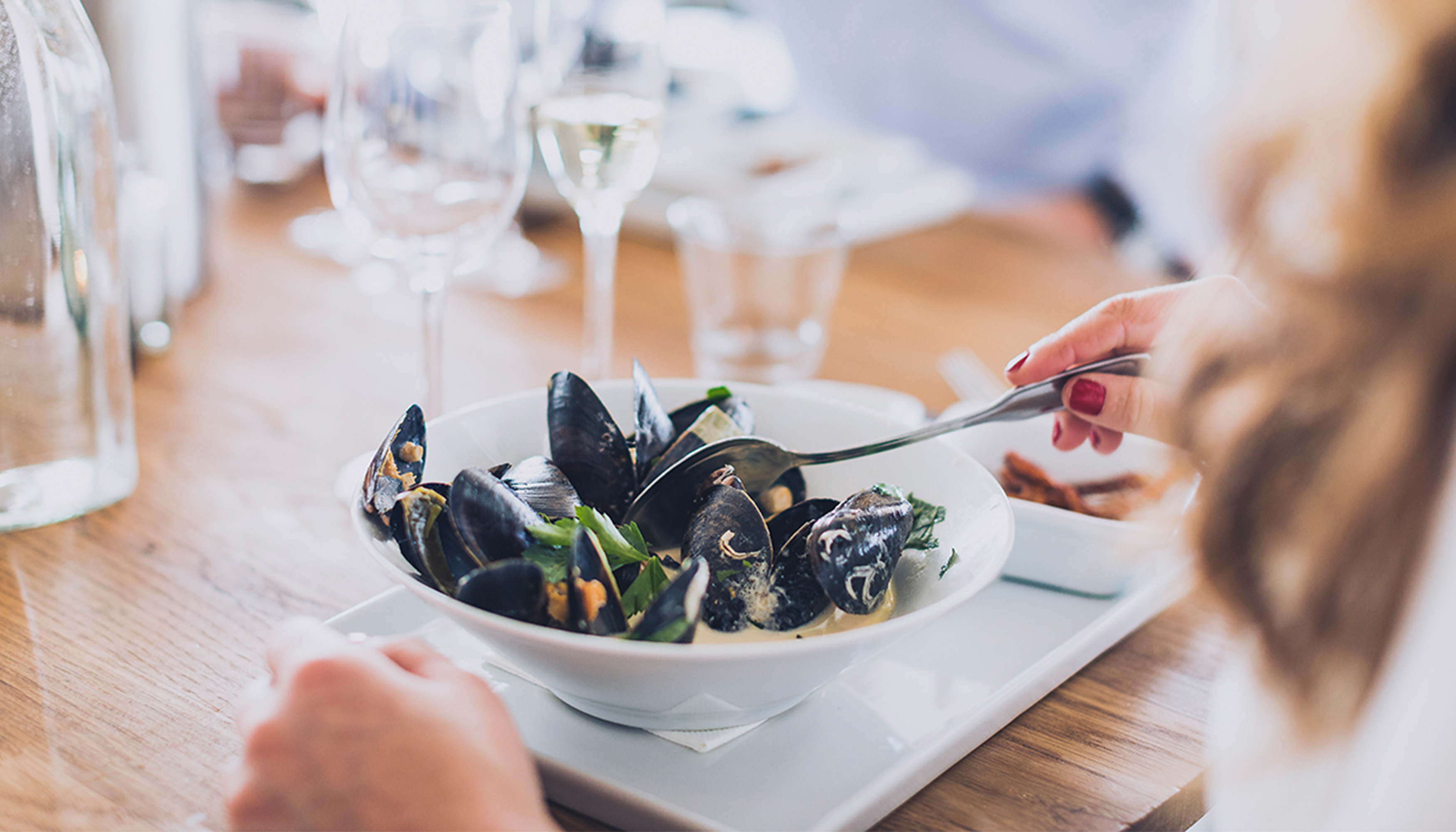 White plate with clam chowder.