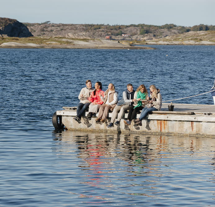Hotel guests sitting on a jetty, Tanumstrand