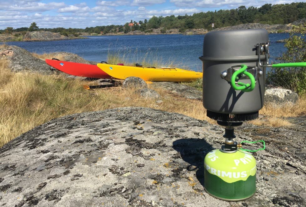 Kayaks and a portable stove on a cliff in the archipelago