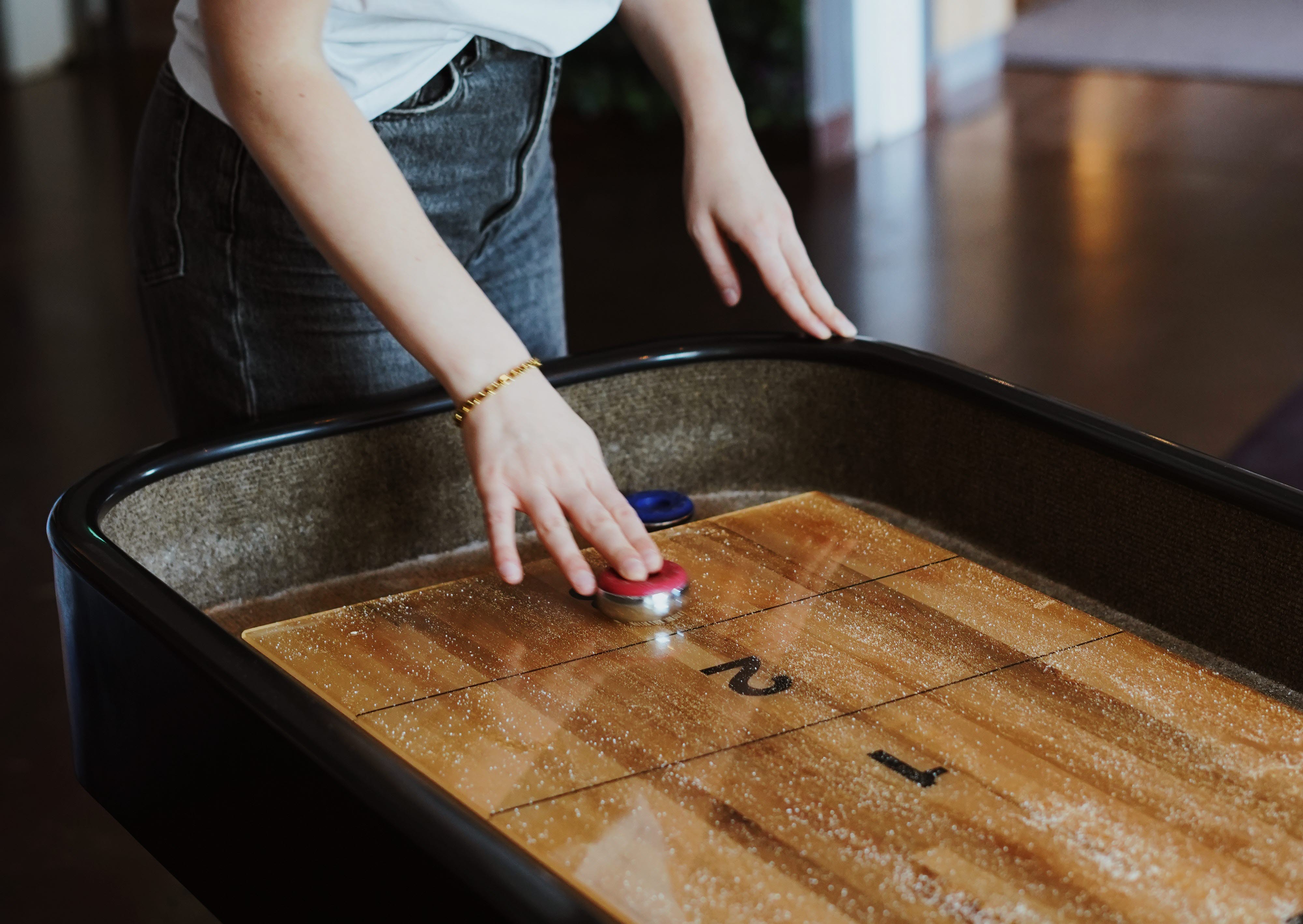 Kvinnlig gäst spelar shufleboard på Quality Hotel Prisma