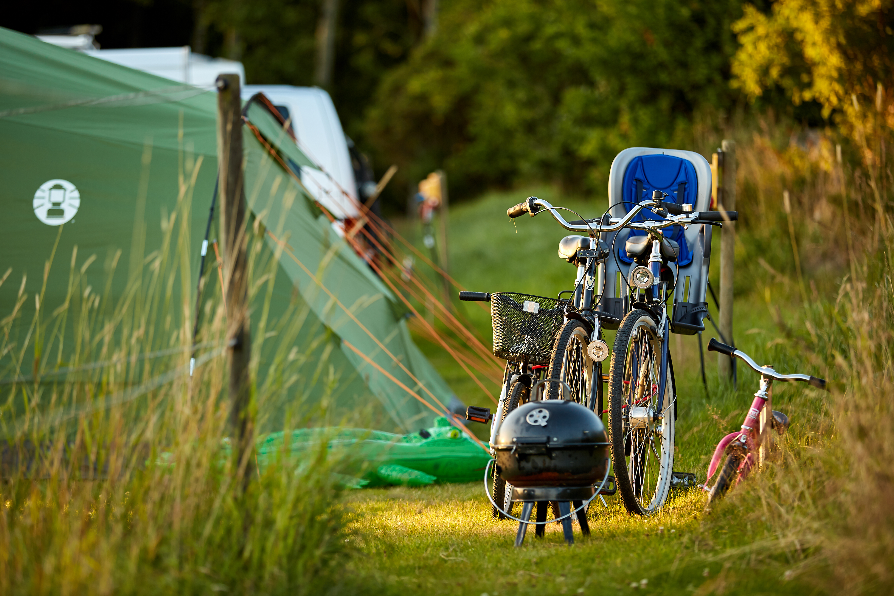 Tents, bicycles and a outdoor B-B-Q grill