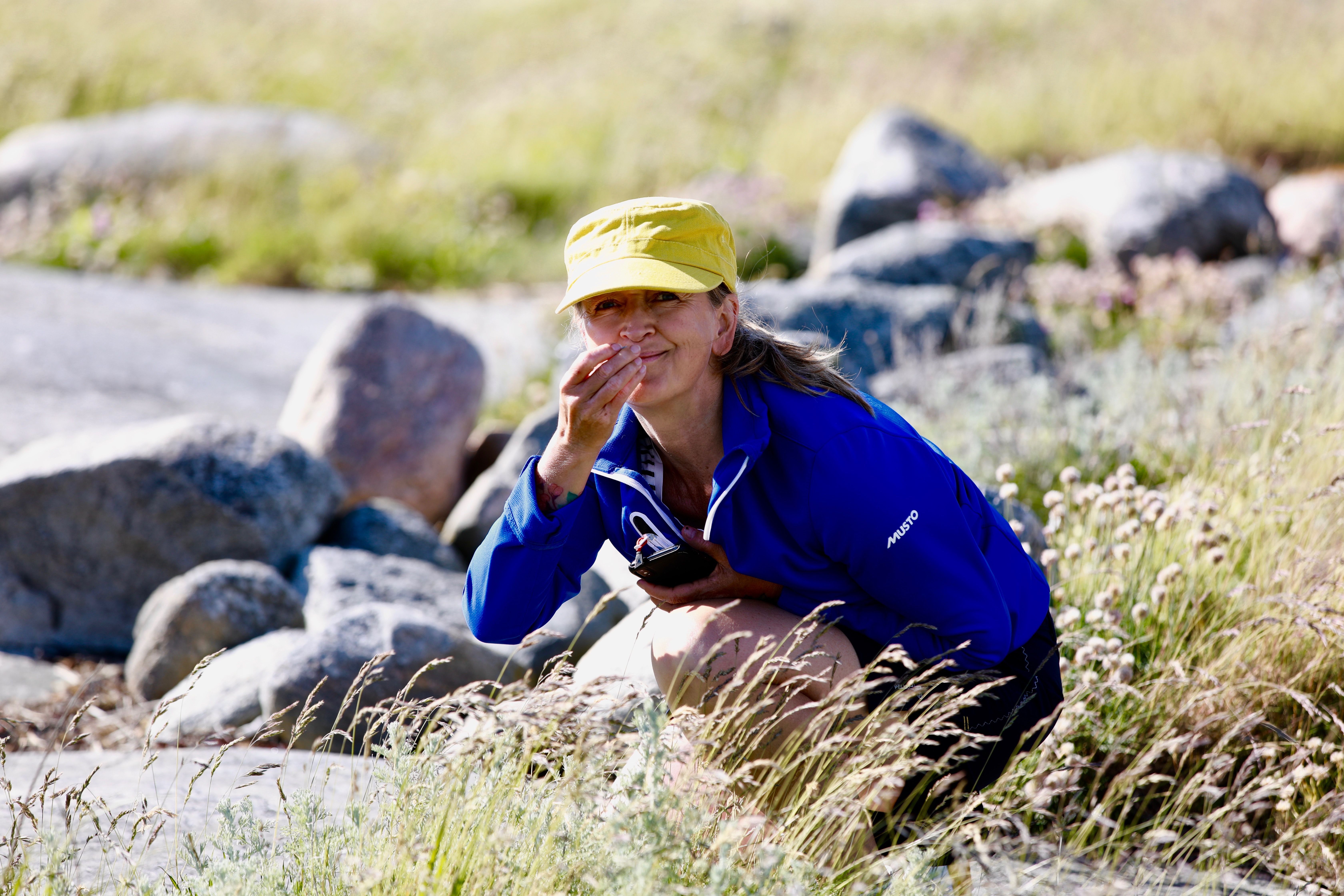 The guide studies some grass in the archipilago
