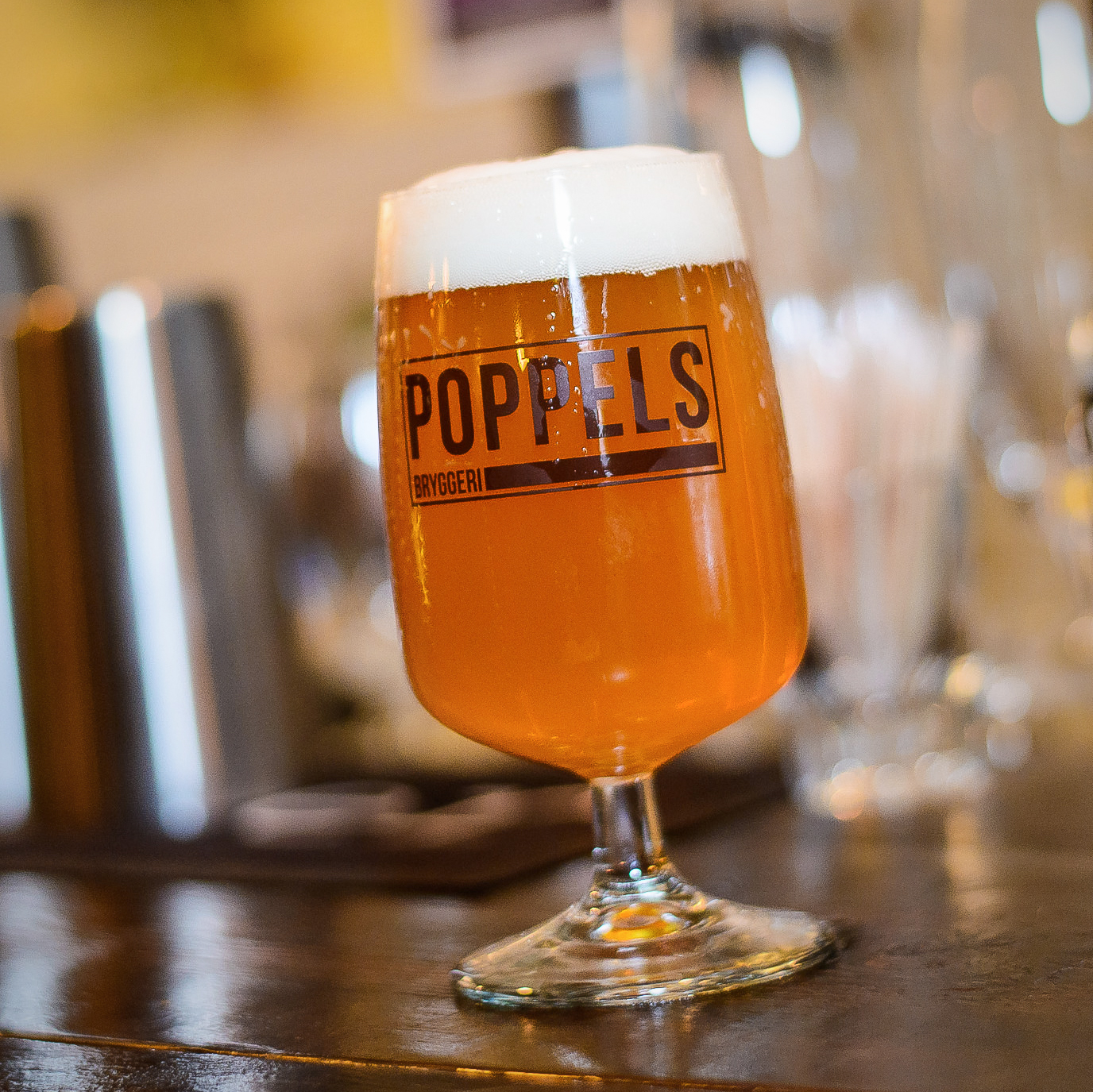 A glass of foaming beer from the micro brewery Poppels Bryggeri.