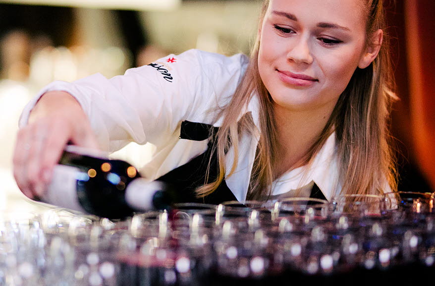 A waitress serves wine at Kajskjul 8