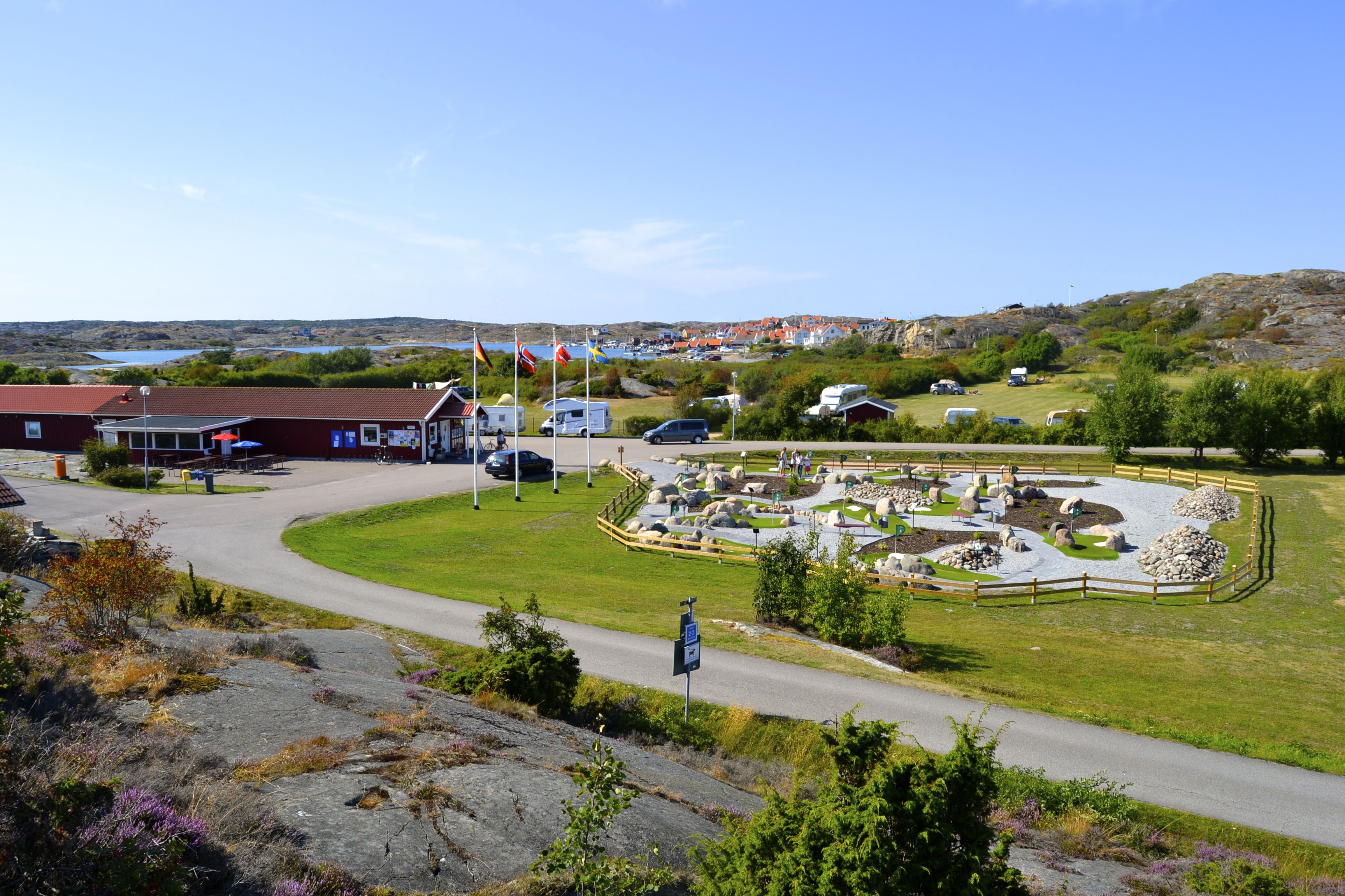Camping site among salty rocks, blue skies and green grass.