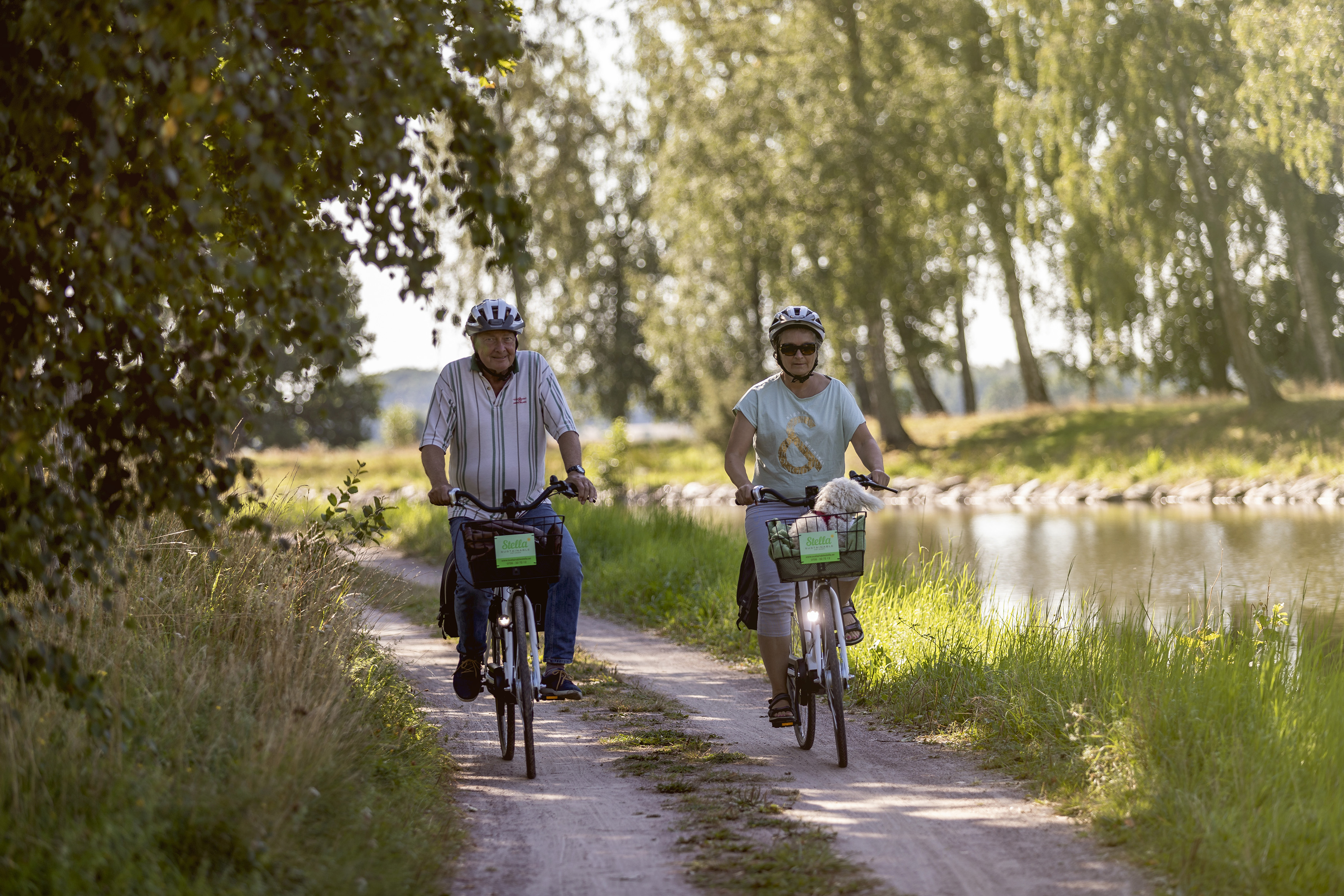 People bicycling along Göta kanal.