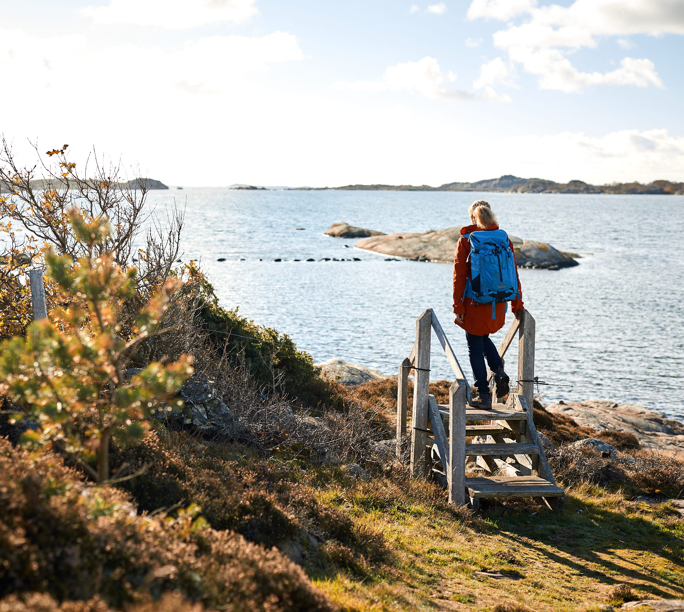 Woman hiking along the coast side.