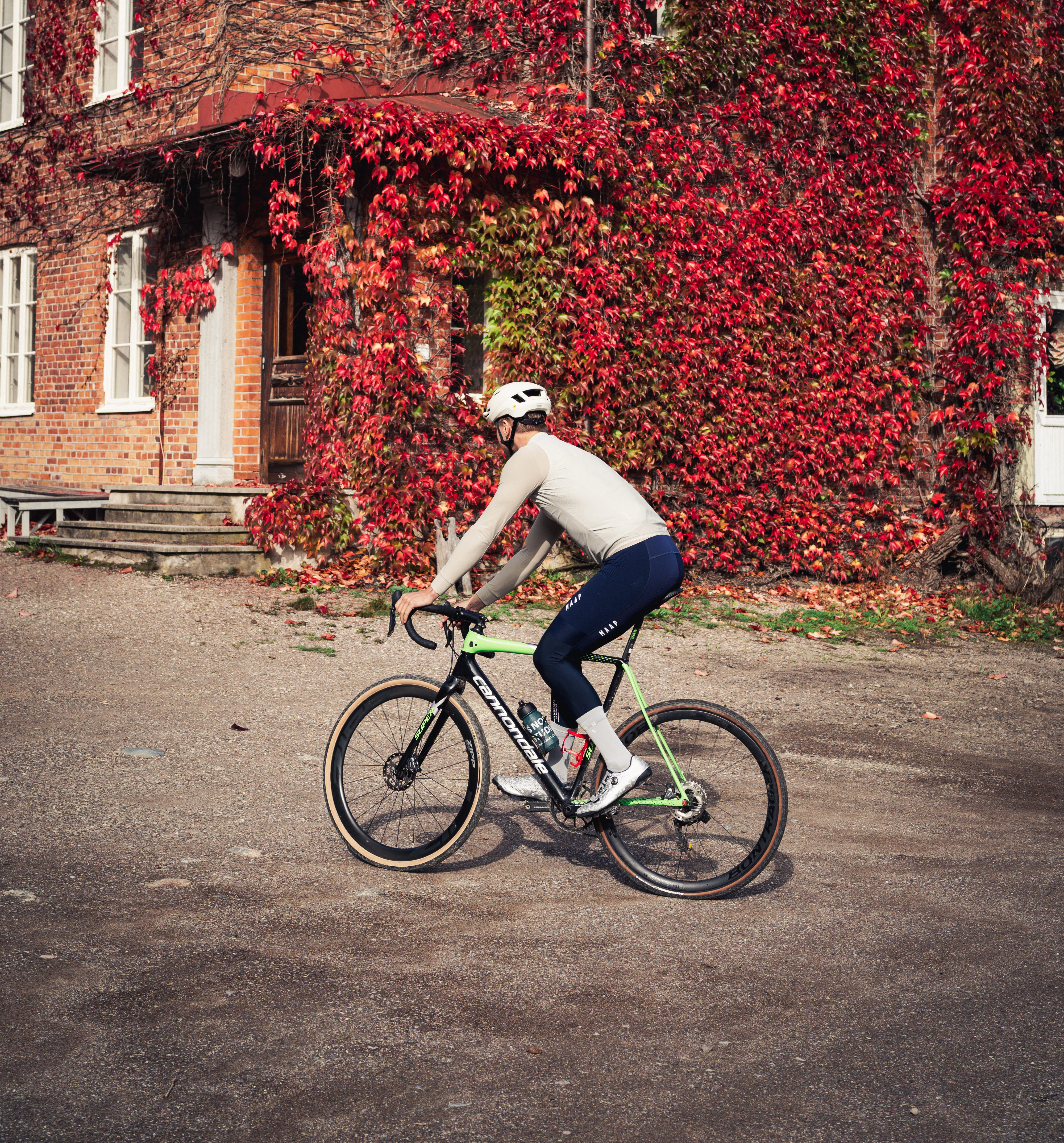 Cyclists on a dirt road in a working environment.