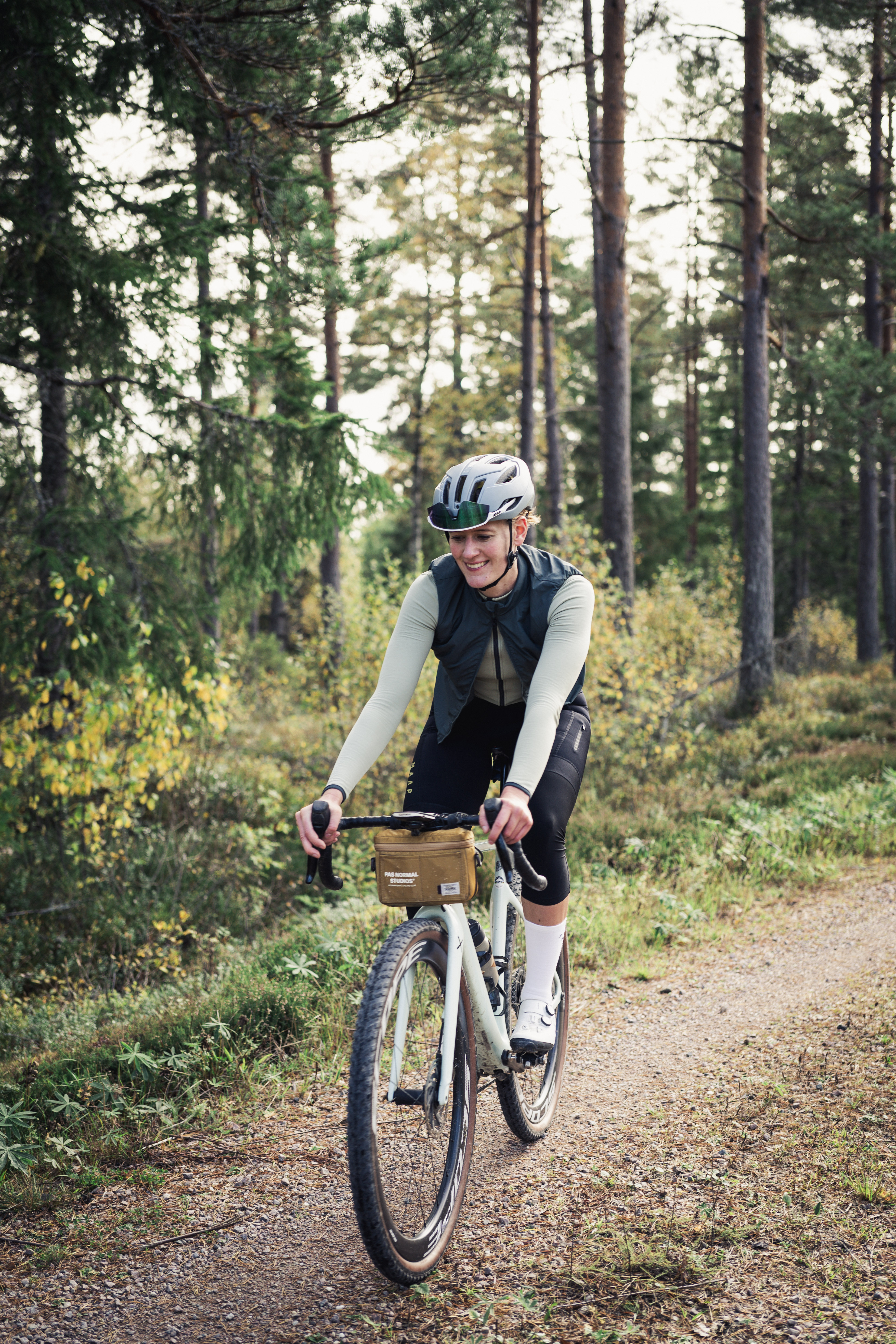 Cyclists on a dirt road in a working environment.