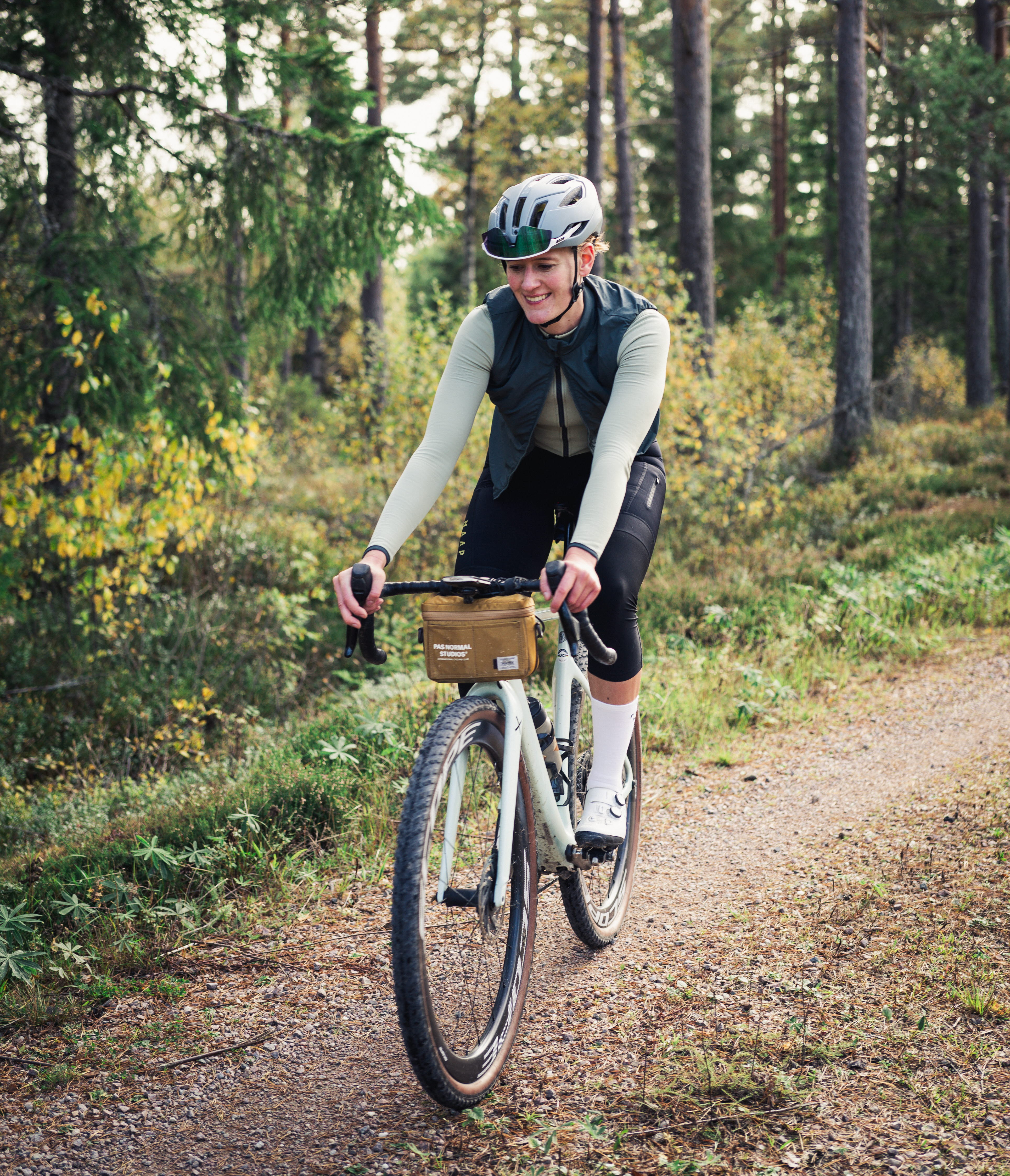 Cyclists on a dirt road in a working environment.
