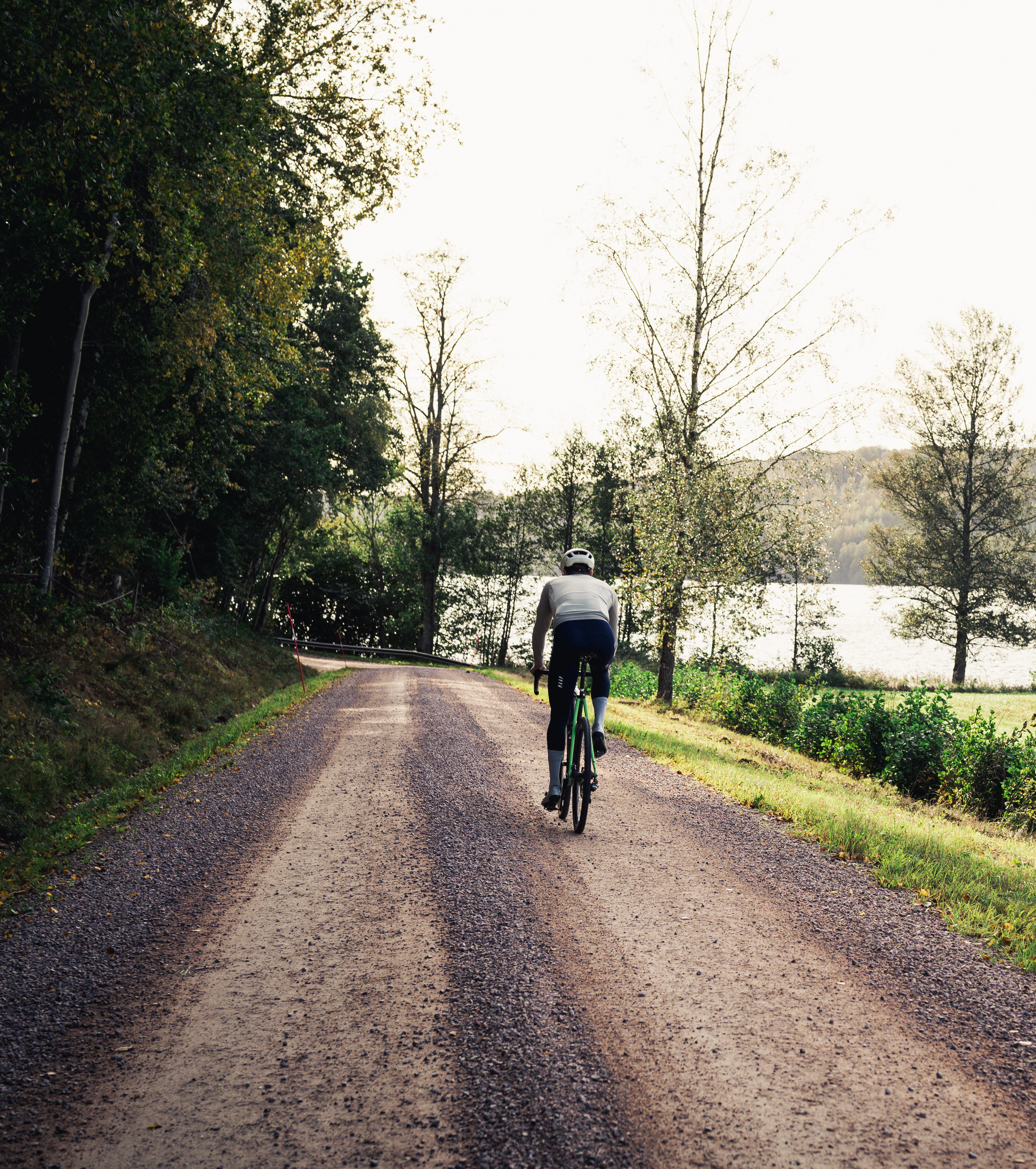 Cyclists on a dirt road in a working environment.