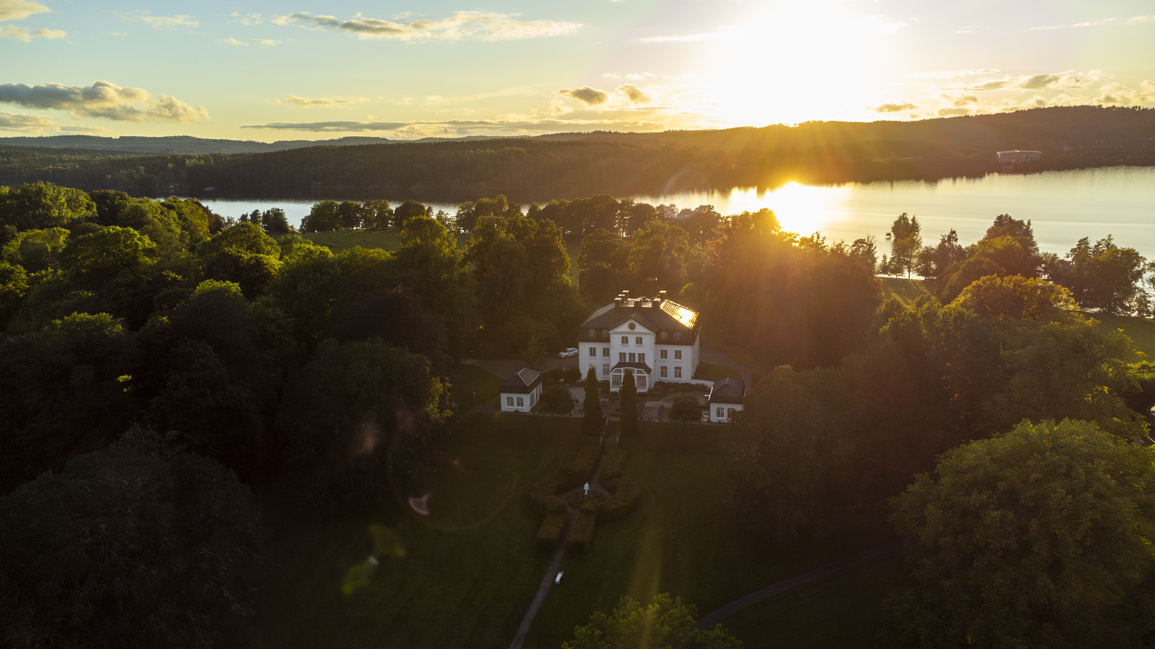 Manor in the forest by a lake