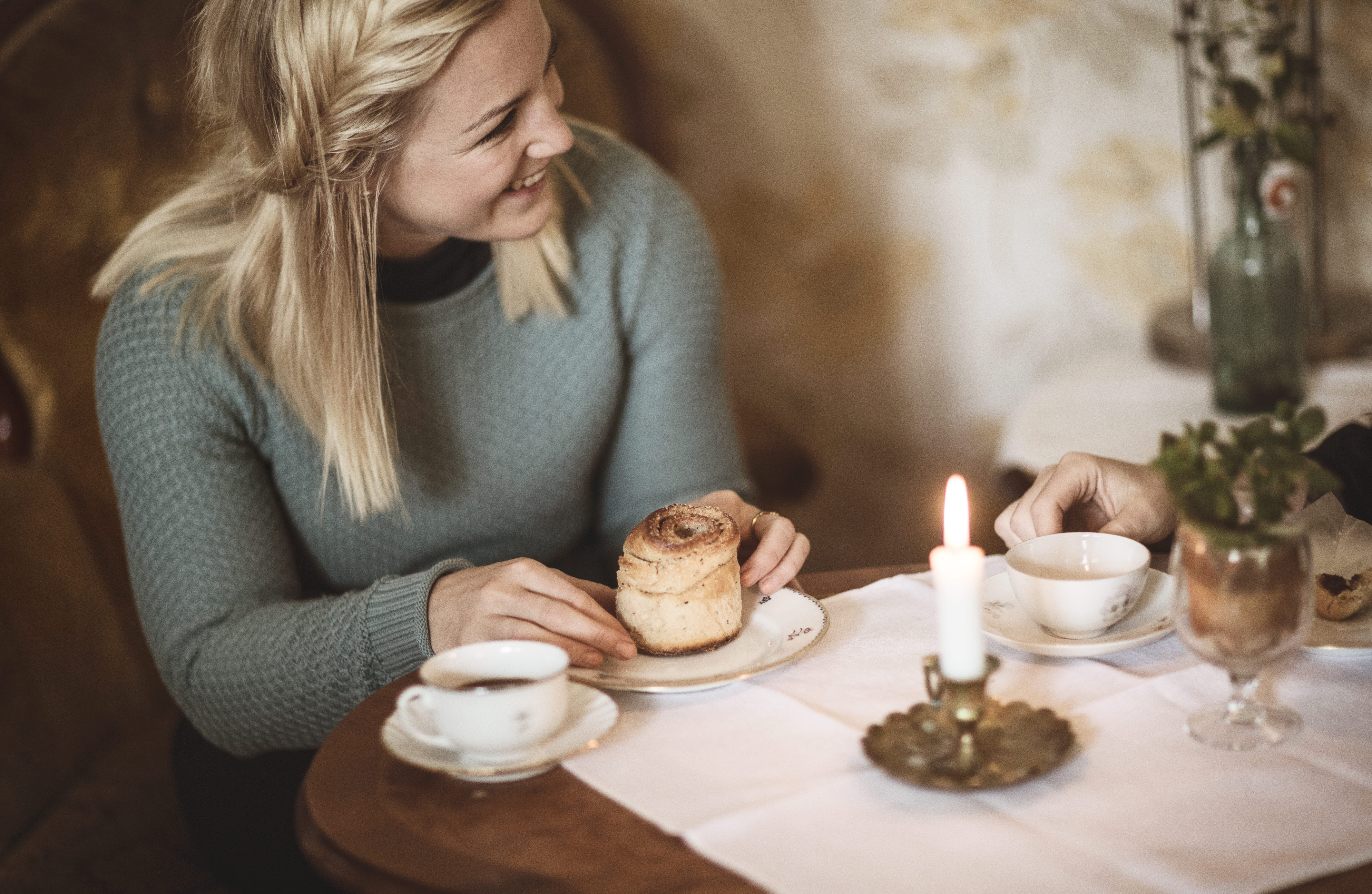 Woman enjoying cinnamon buns and coffee