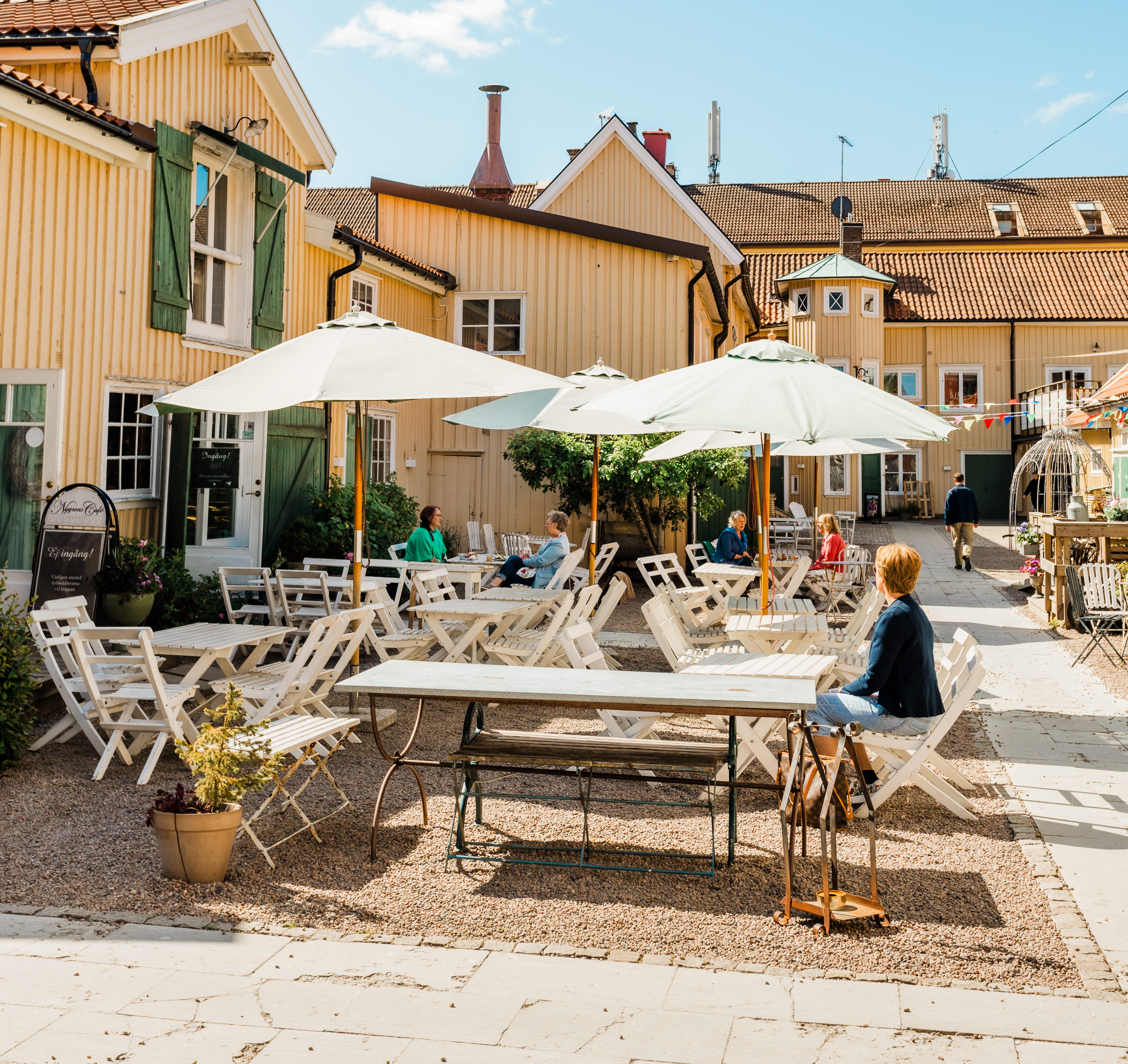 Group of people sitting on an outdoor terrace.