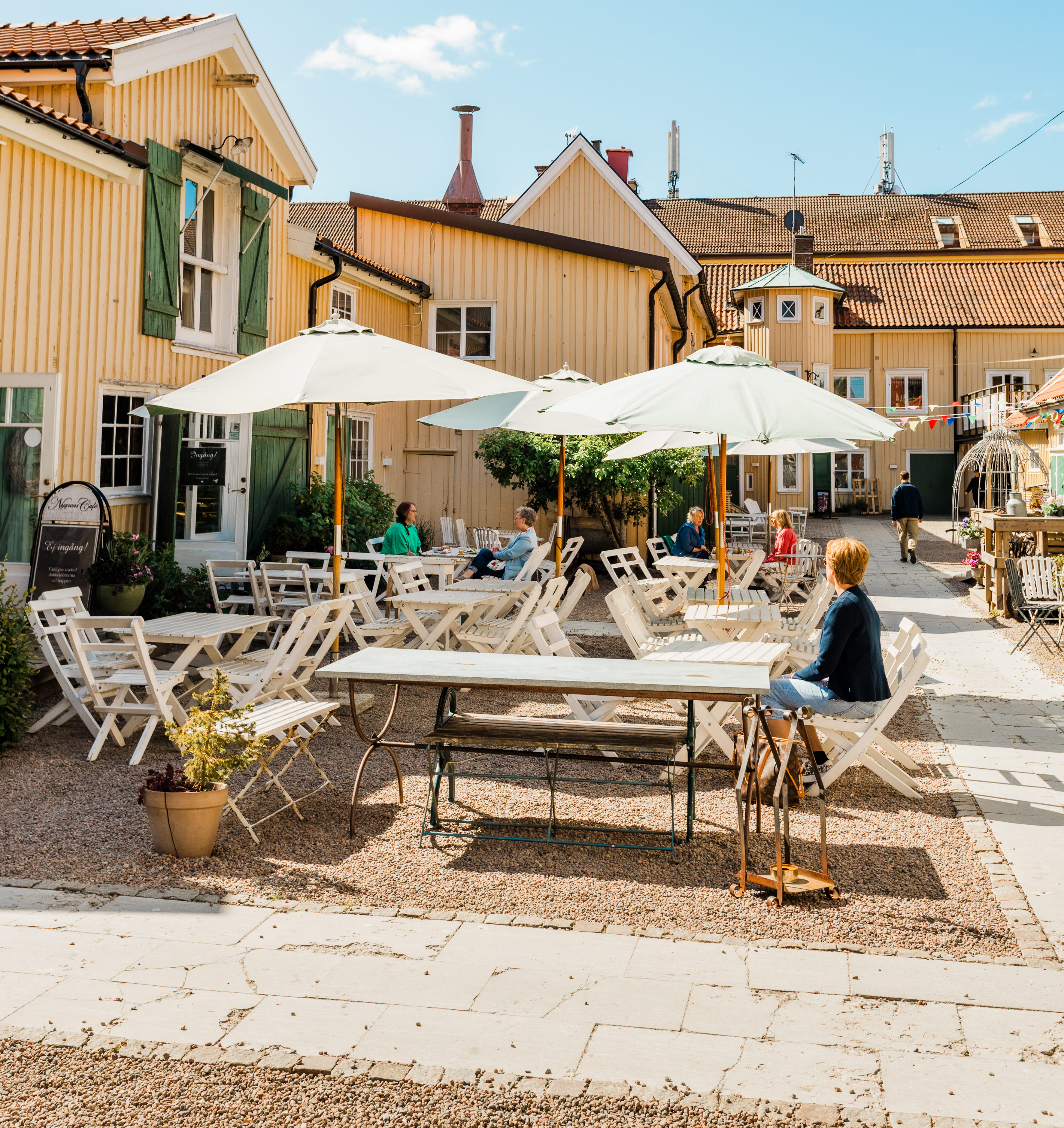 Group of people sitting on an outdoor terrace.