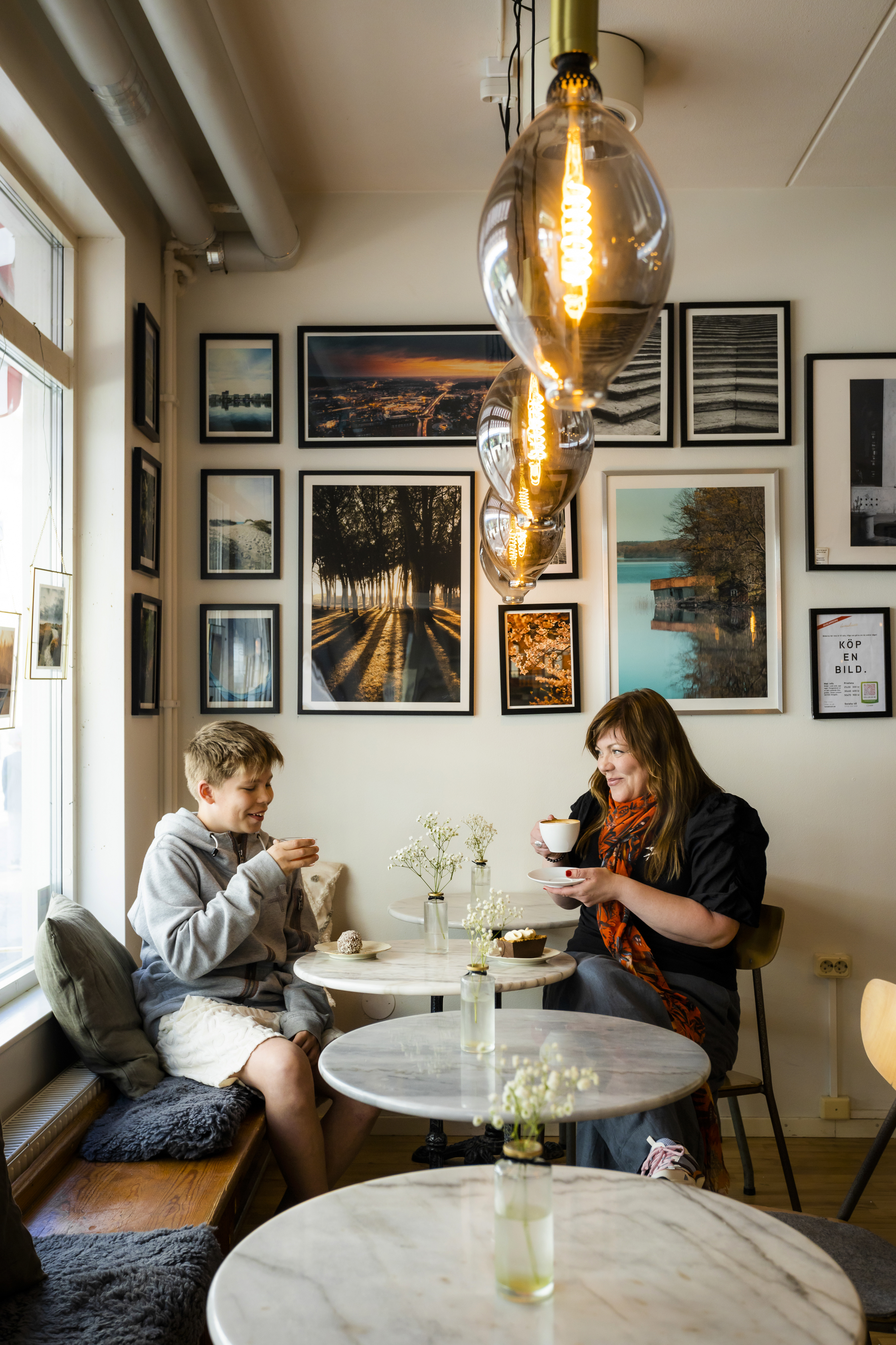 Woman having coffee together with a teenager.