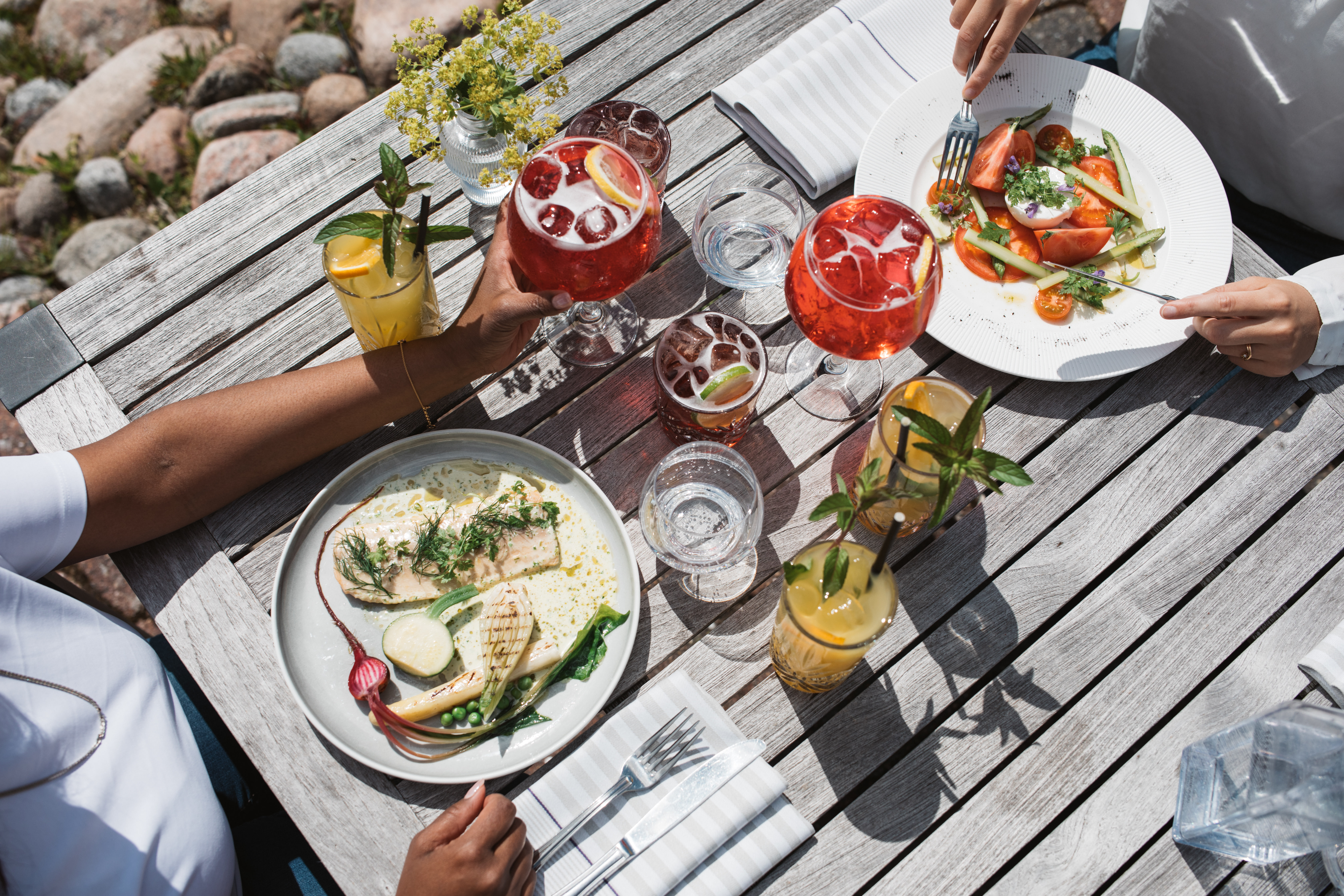 Food laid out on a summery table outside.