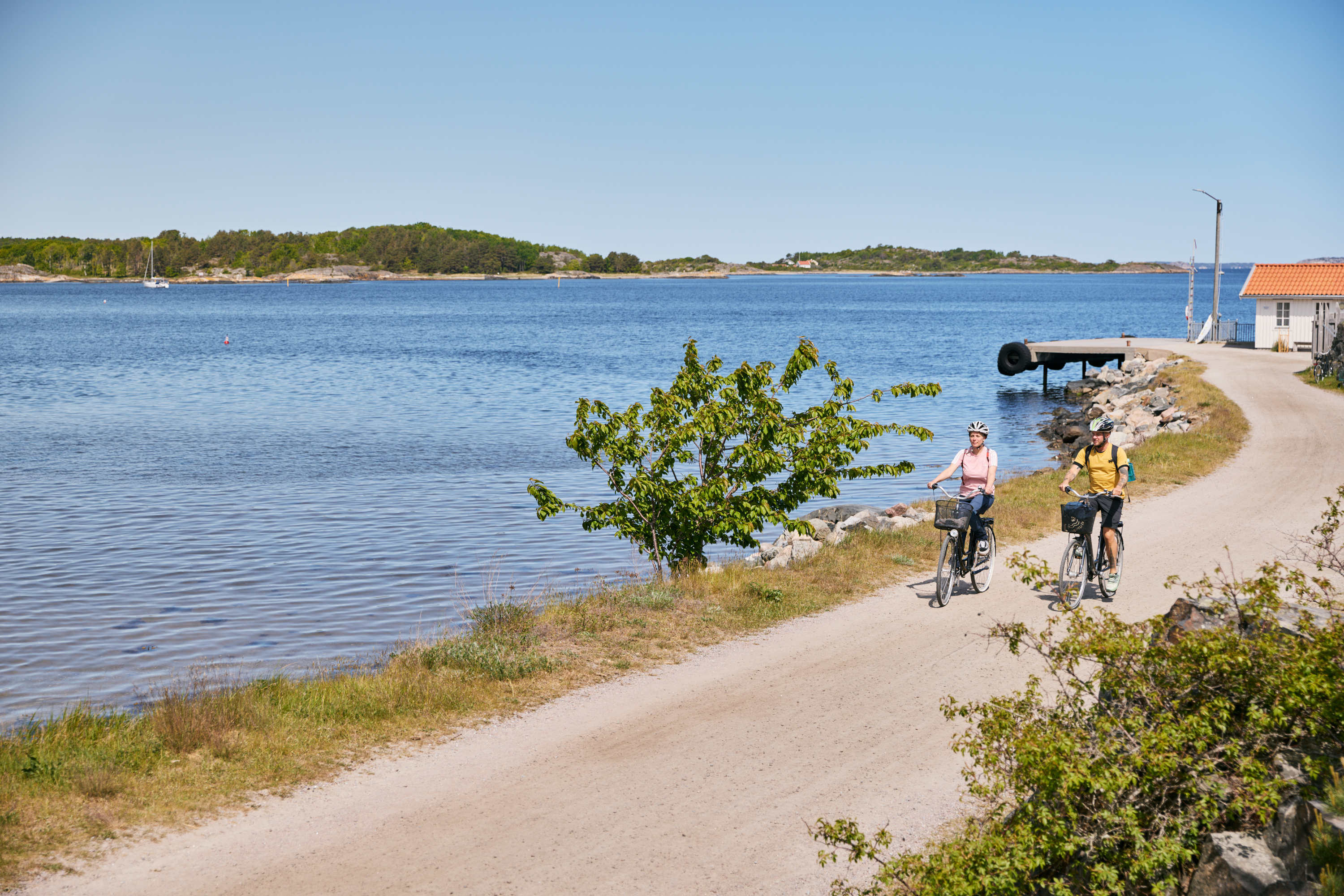 Two people are cycling on an island.