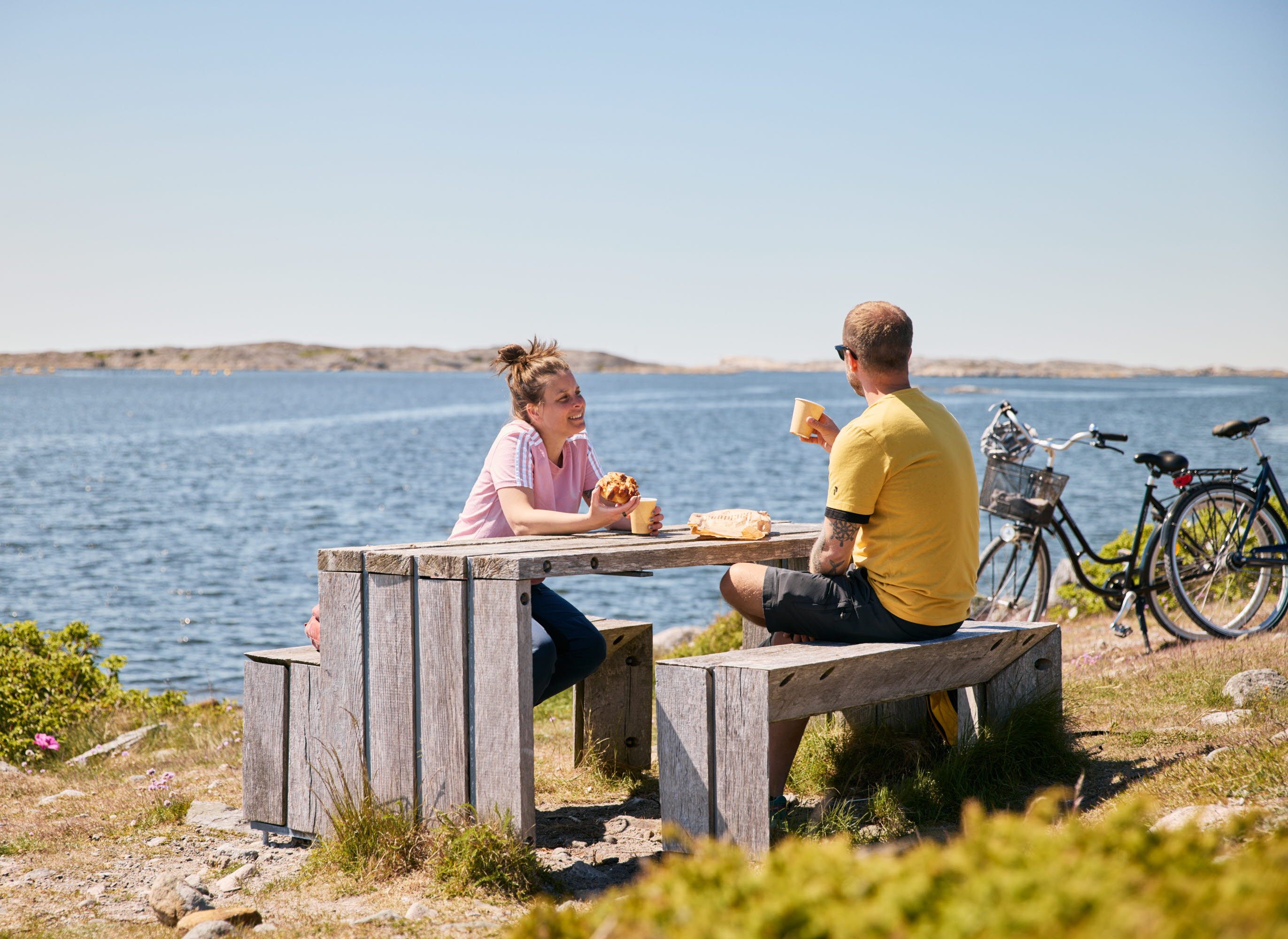 Two people having coffee at a table.