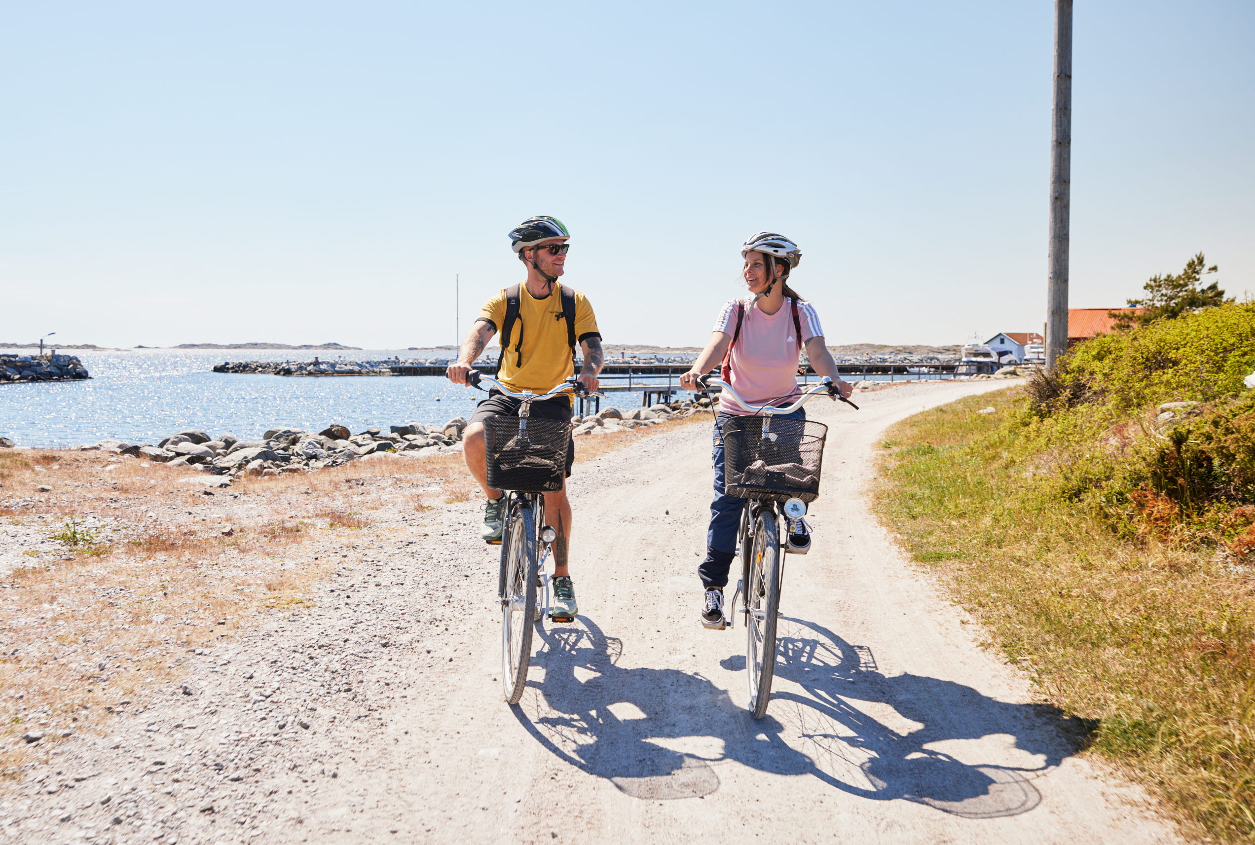 Two people are cycling on an island.