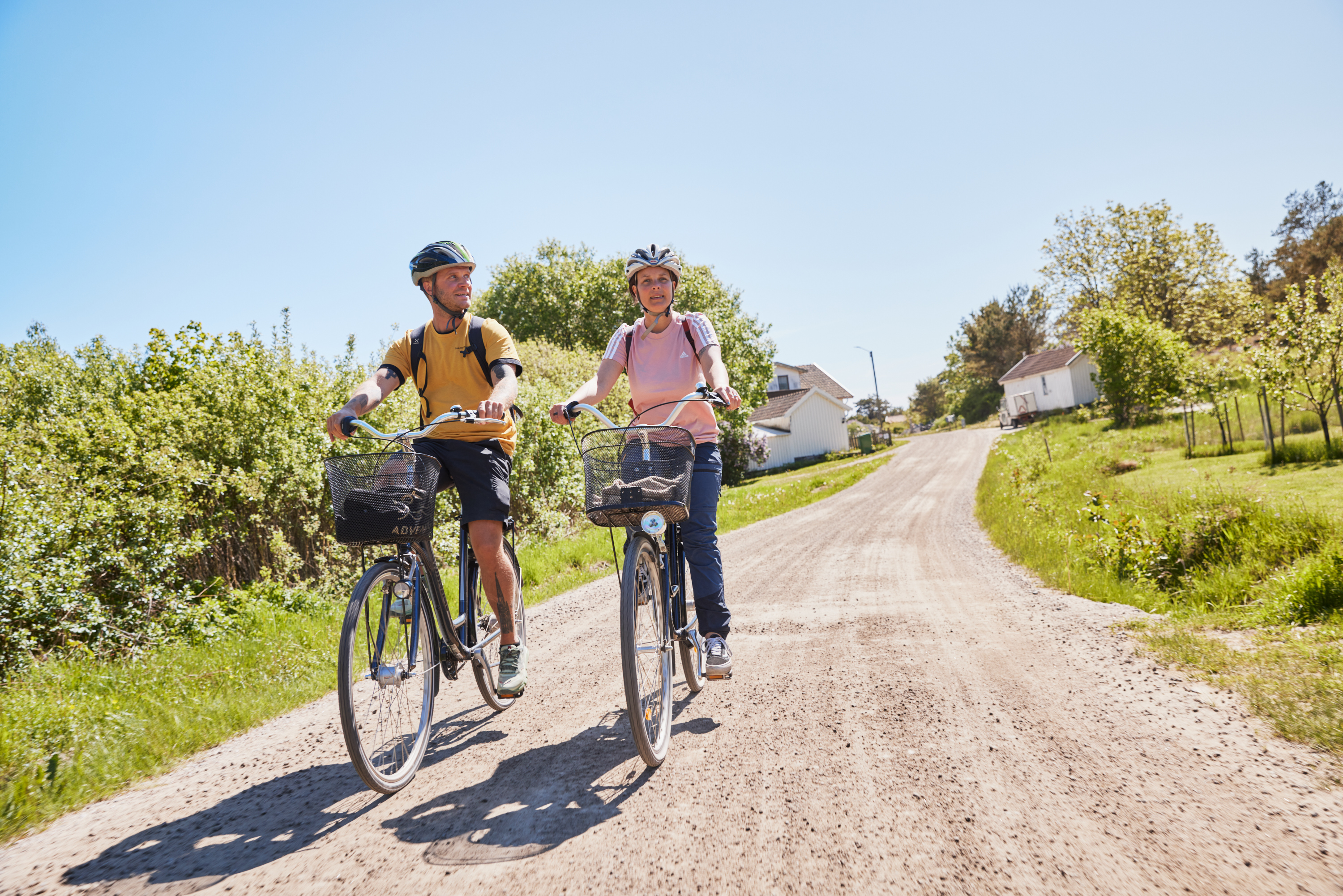 Two people are cycling on an island.