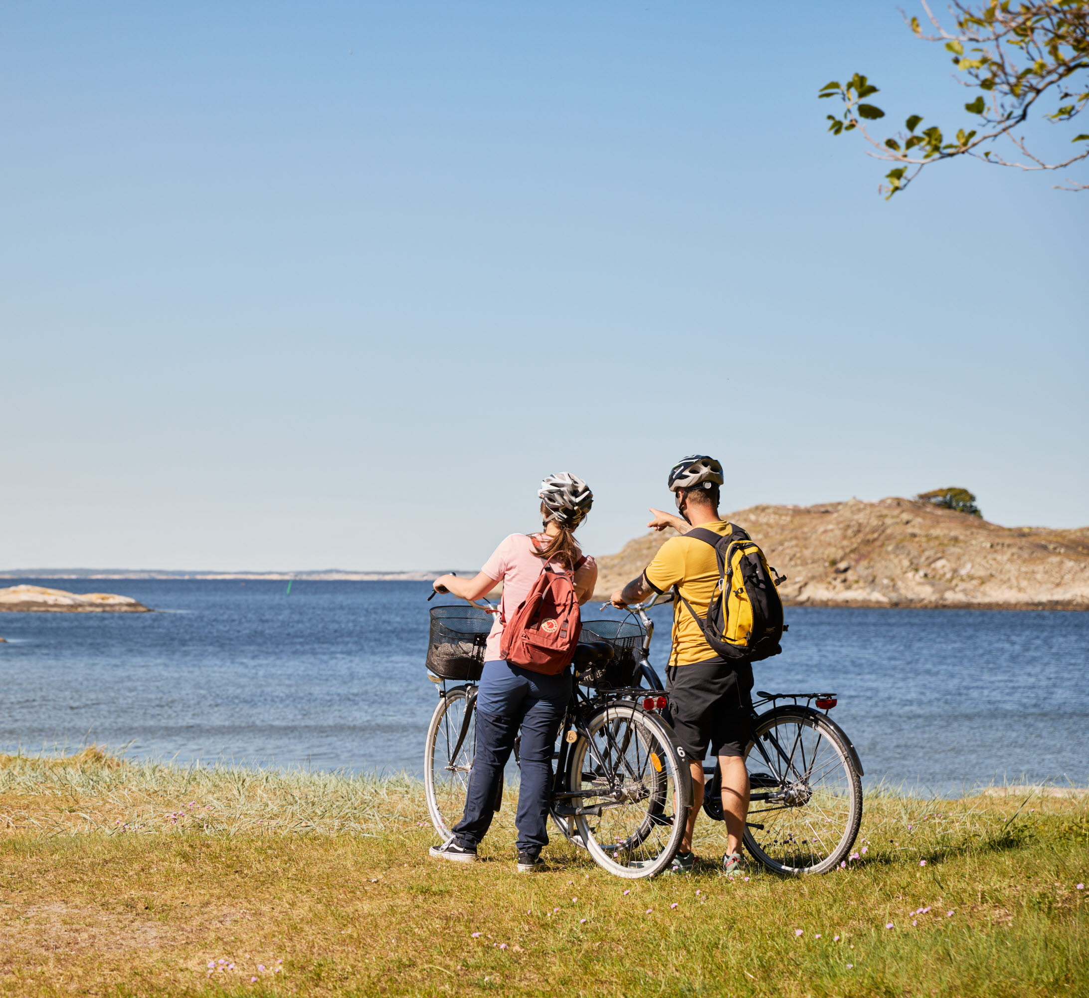 Two people are cycling on an island.