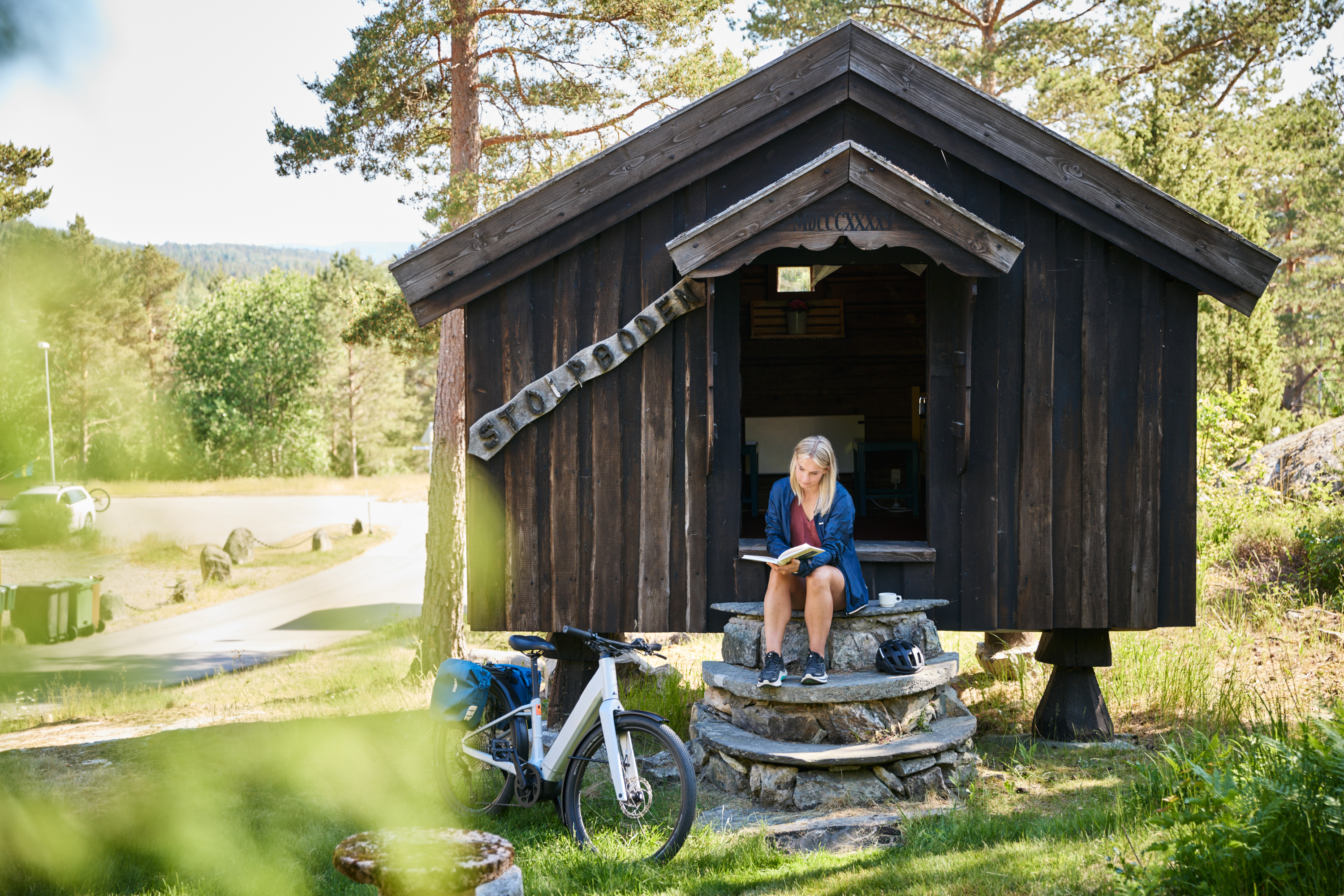 A woman sitting with a book.