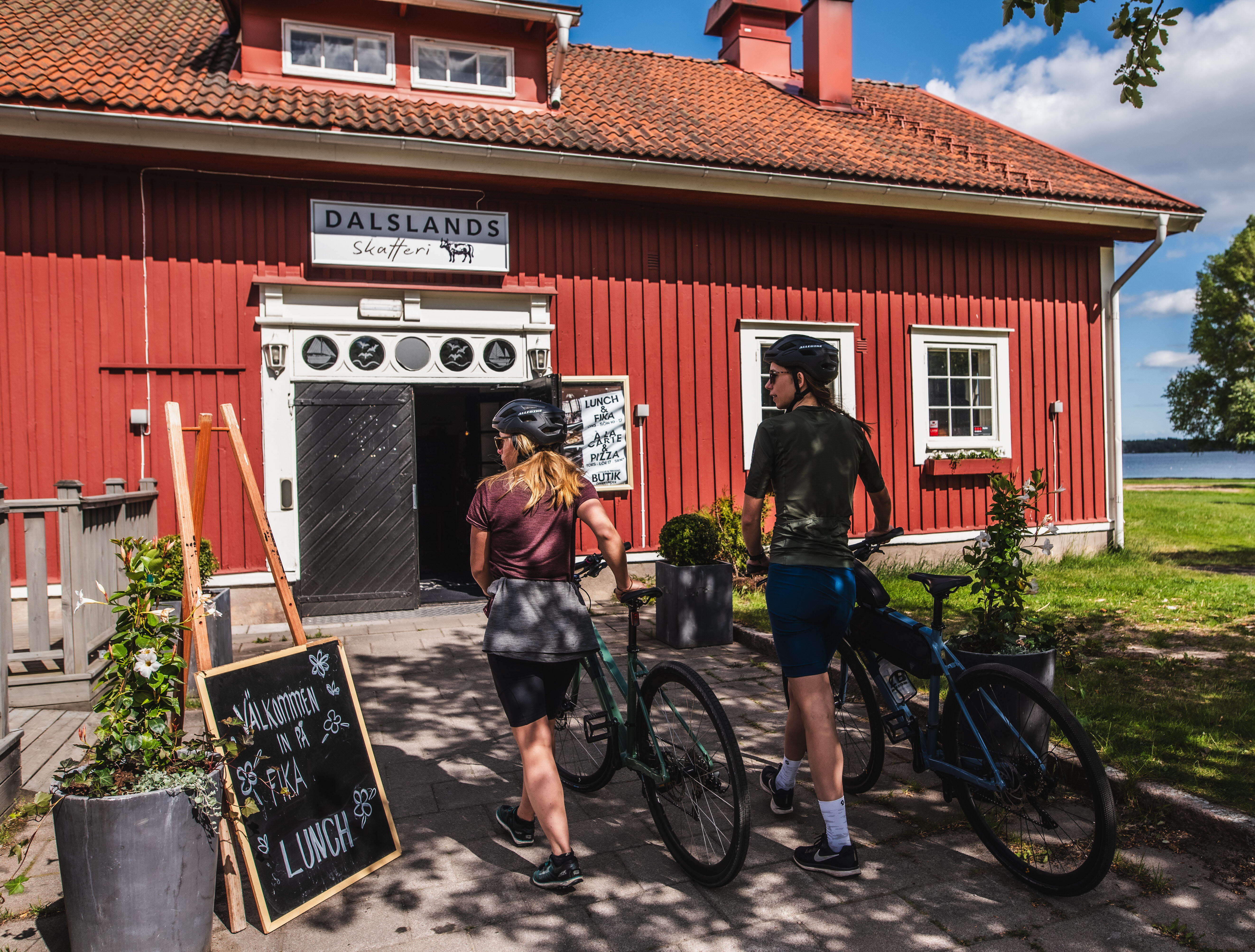 Två kvinnor leder sina cyklar.