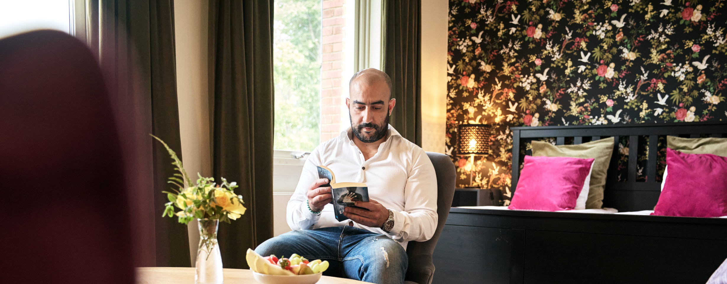 A man reading at First Hotel Bengtsfors