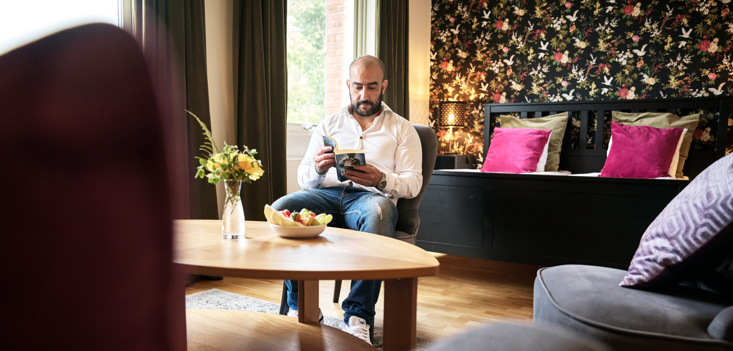 A man reading at First Hotel Bengtsfors