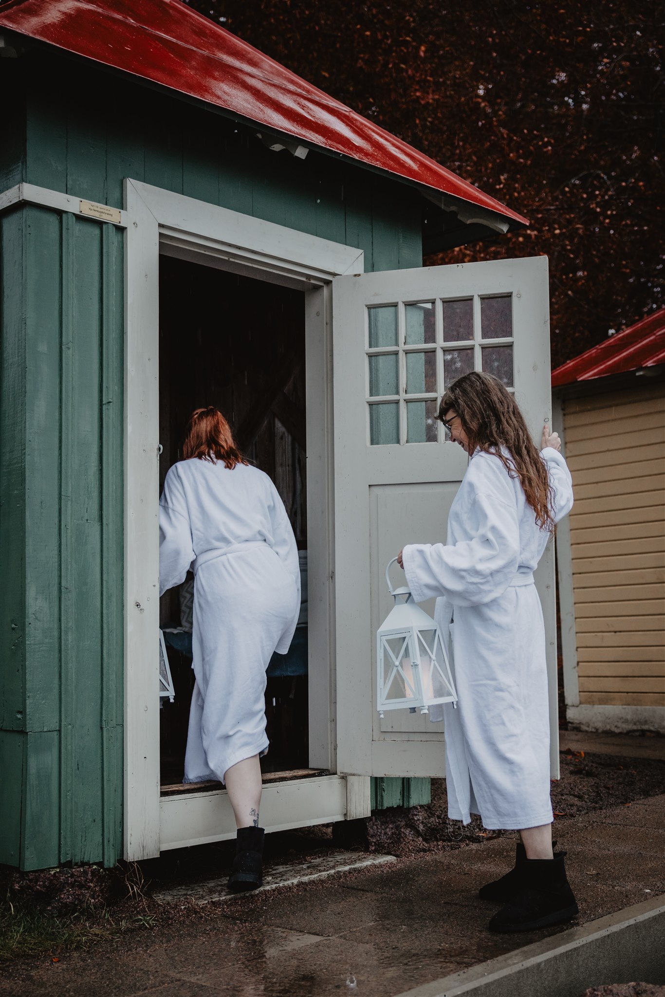 Women socialize in bathrobes.