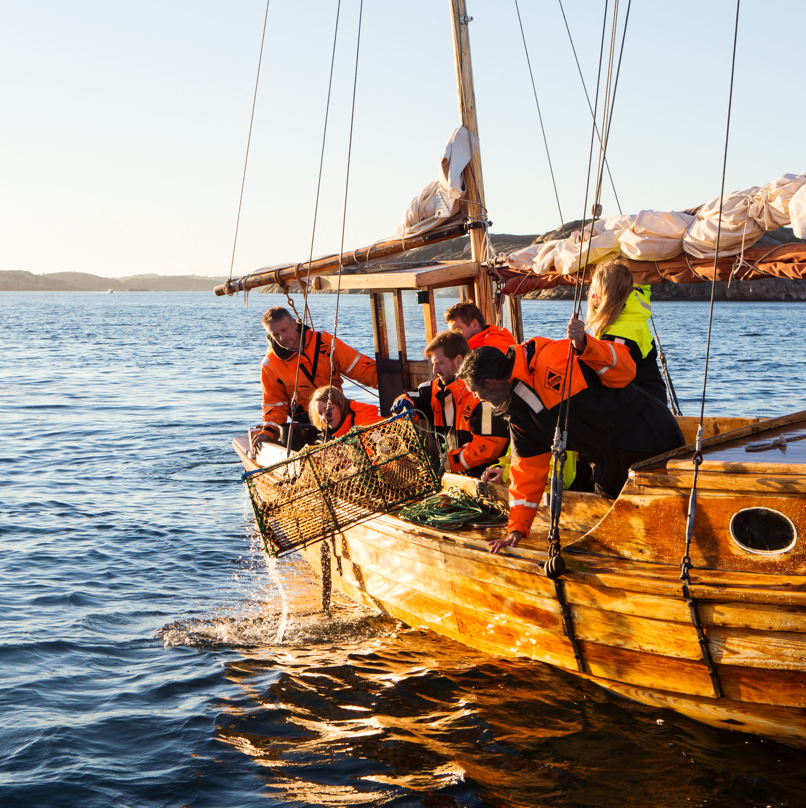Sällskap i träbåt tar upp hummertinaa