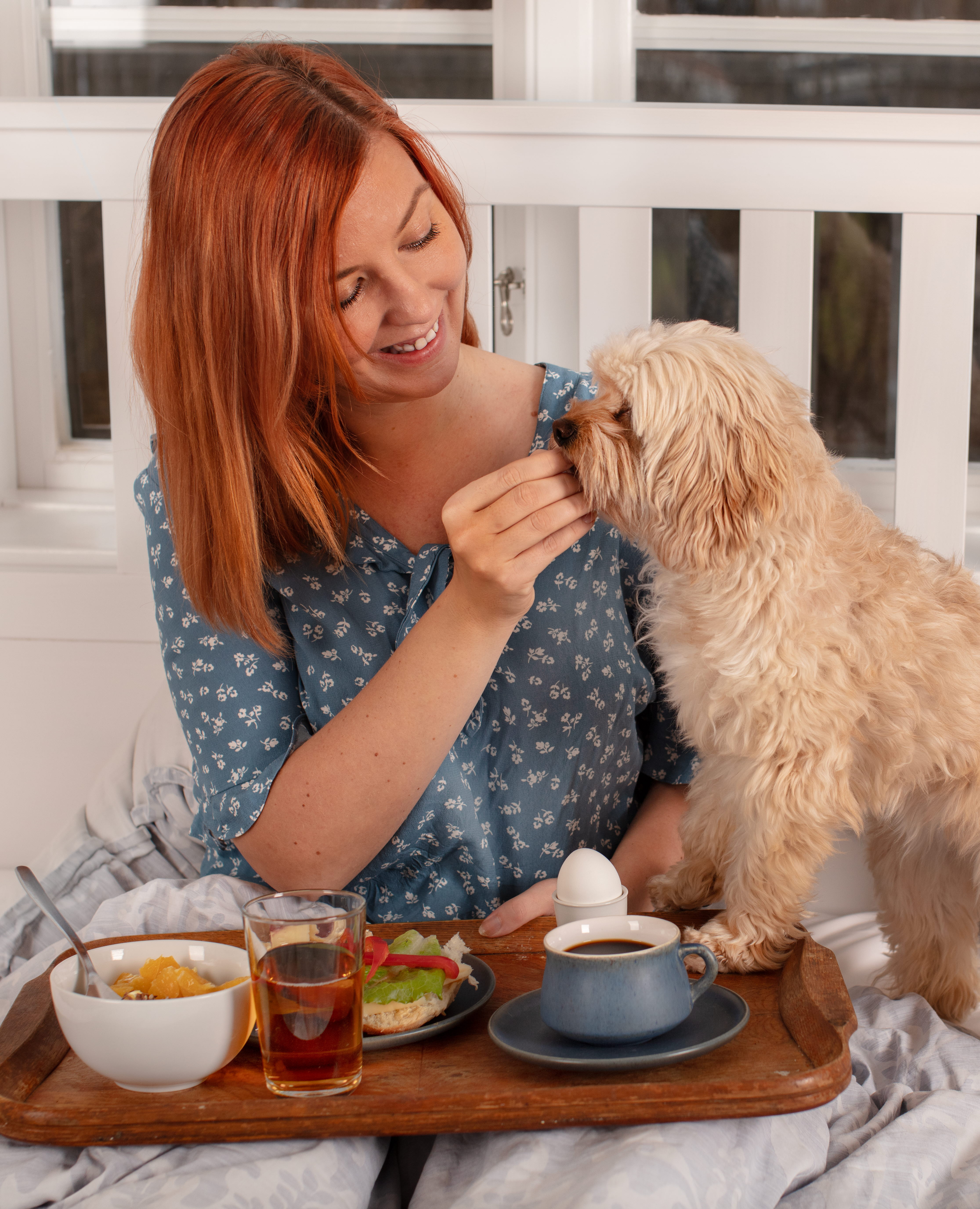 Kvinna med en hund i boendemiljö.