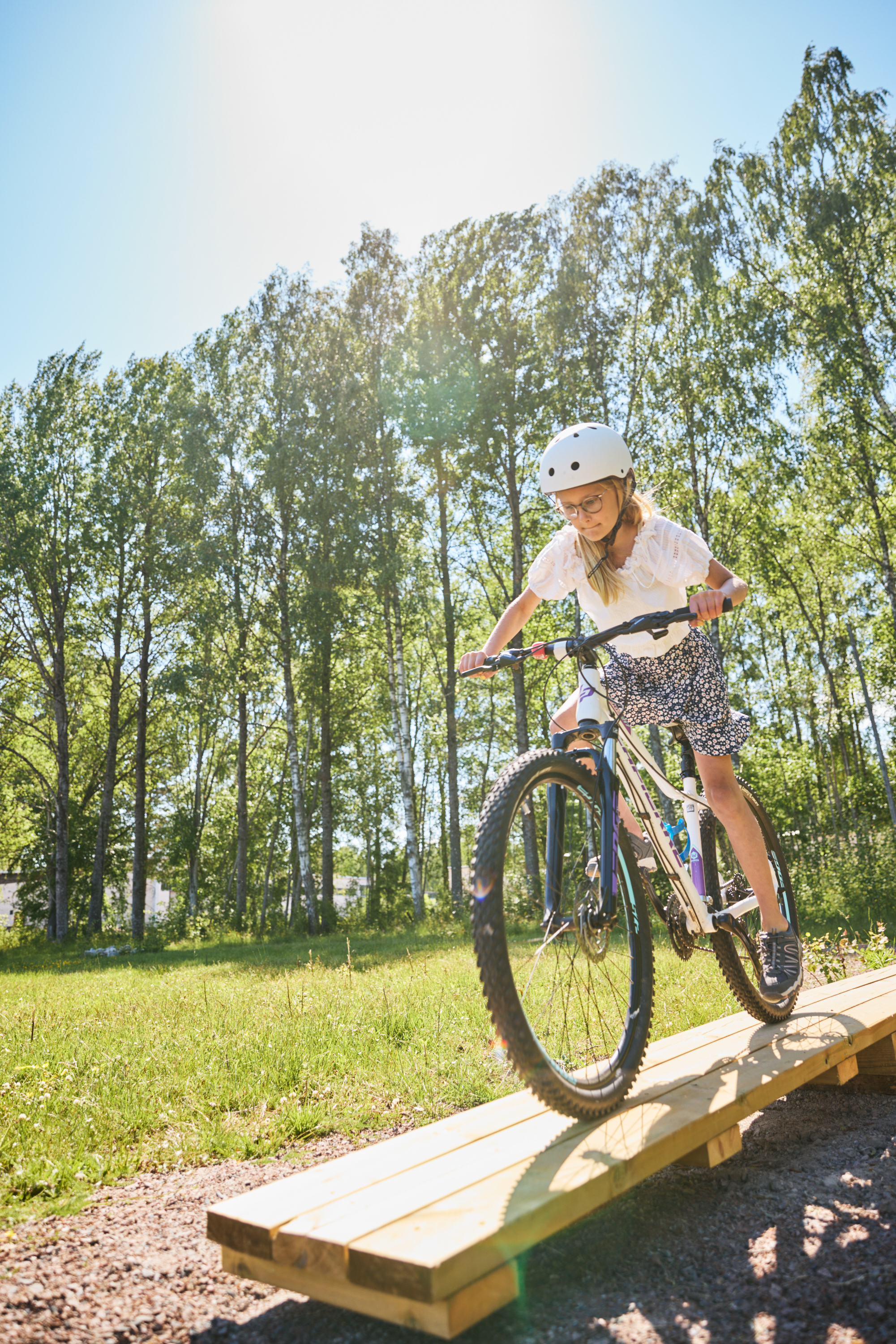 A girl rides a bike.