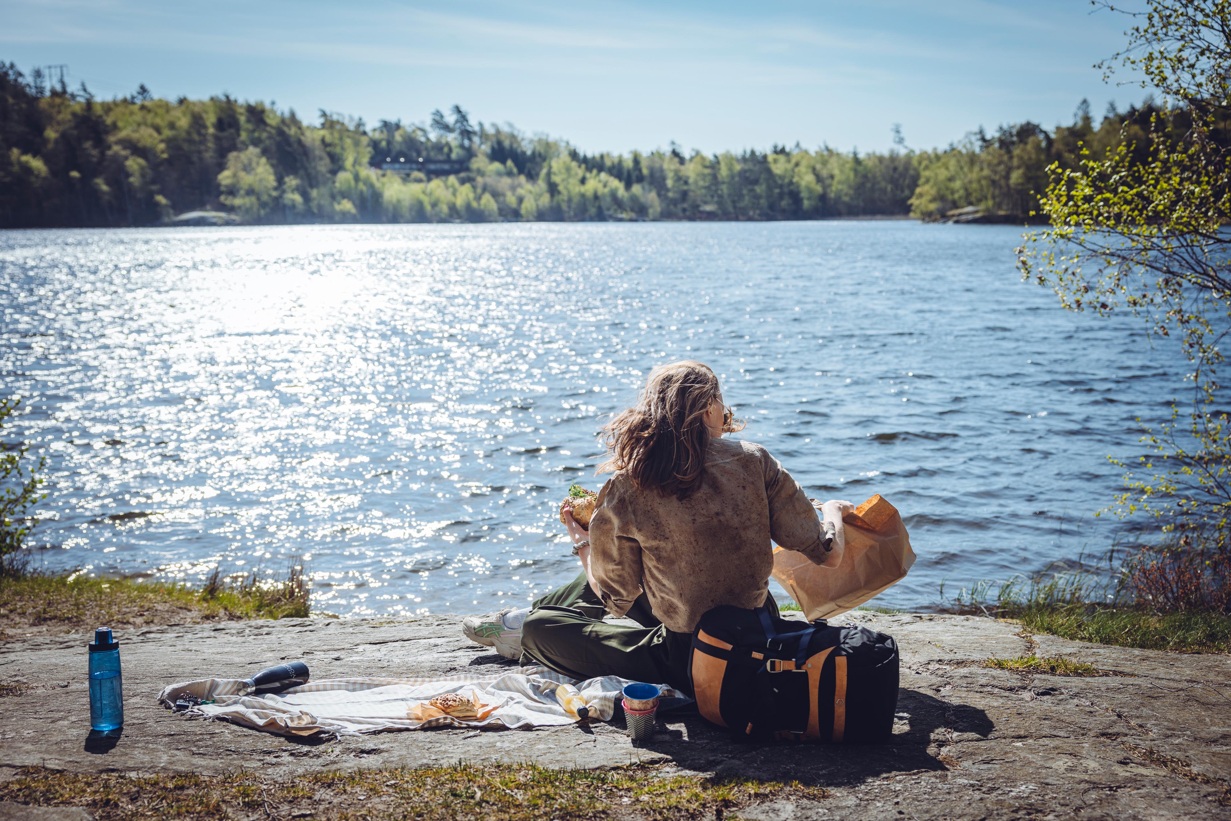 Woman takes a break by a lake.