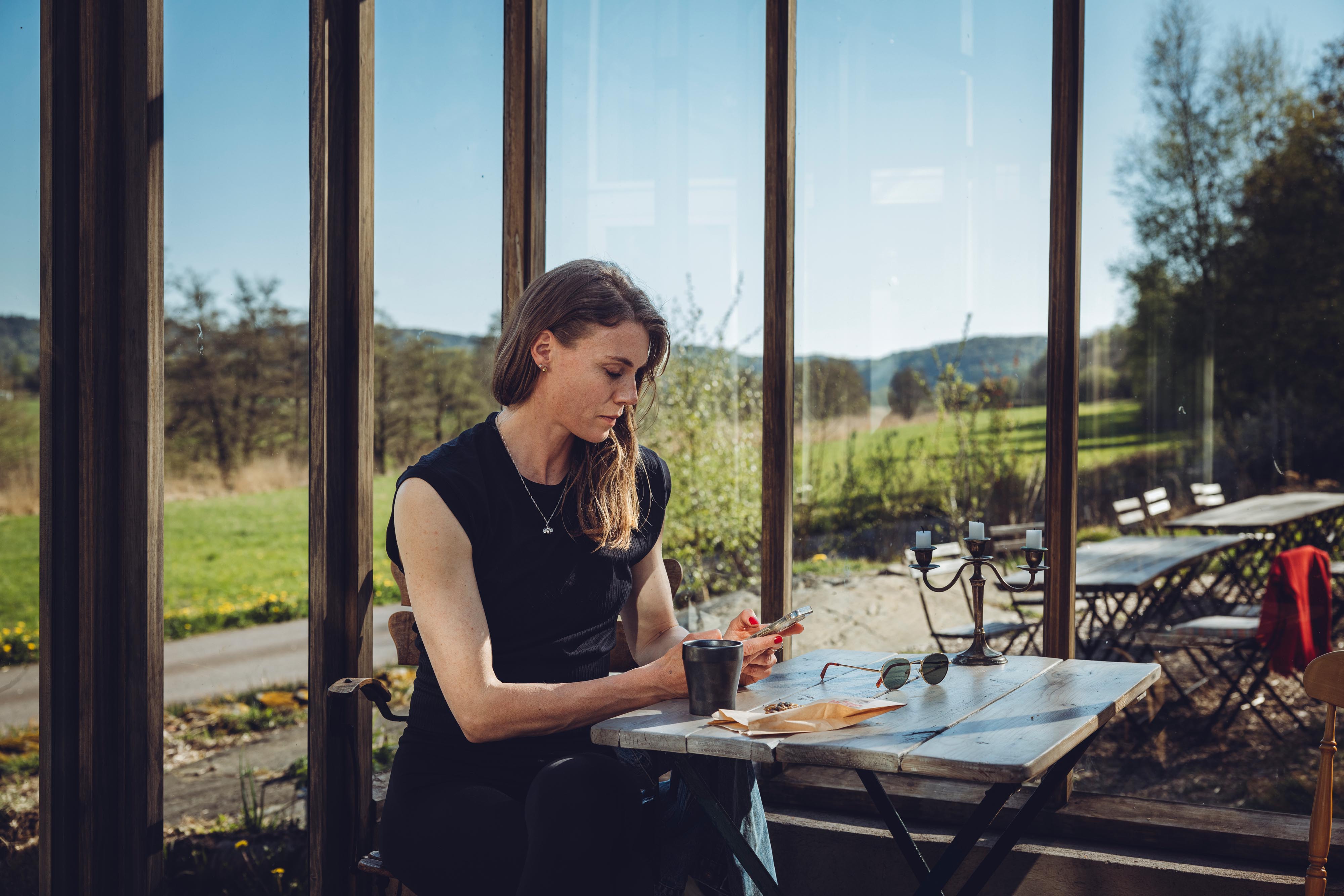 Woman having coffee at Skåra farm bakery.
