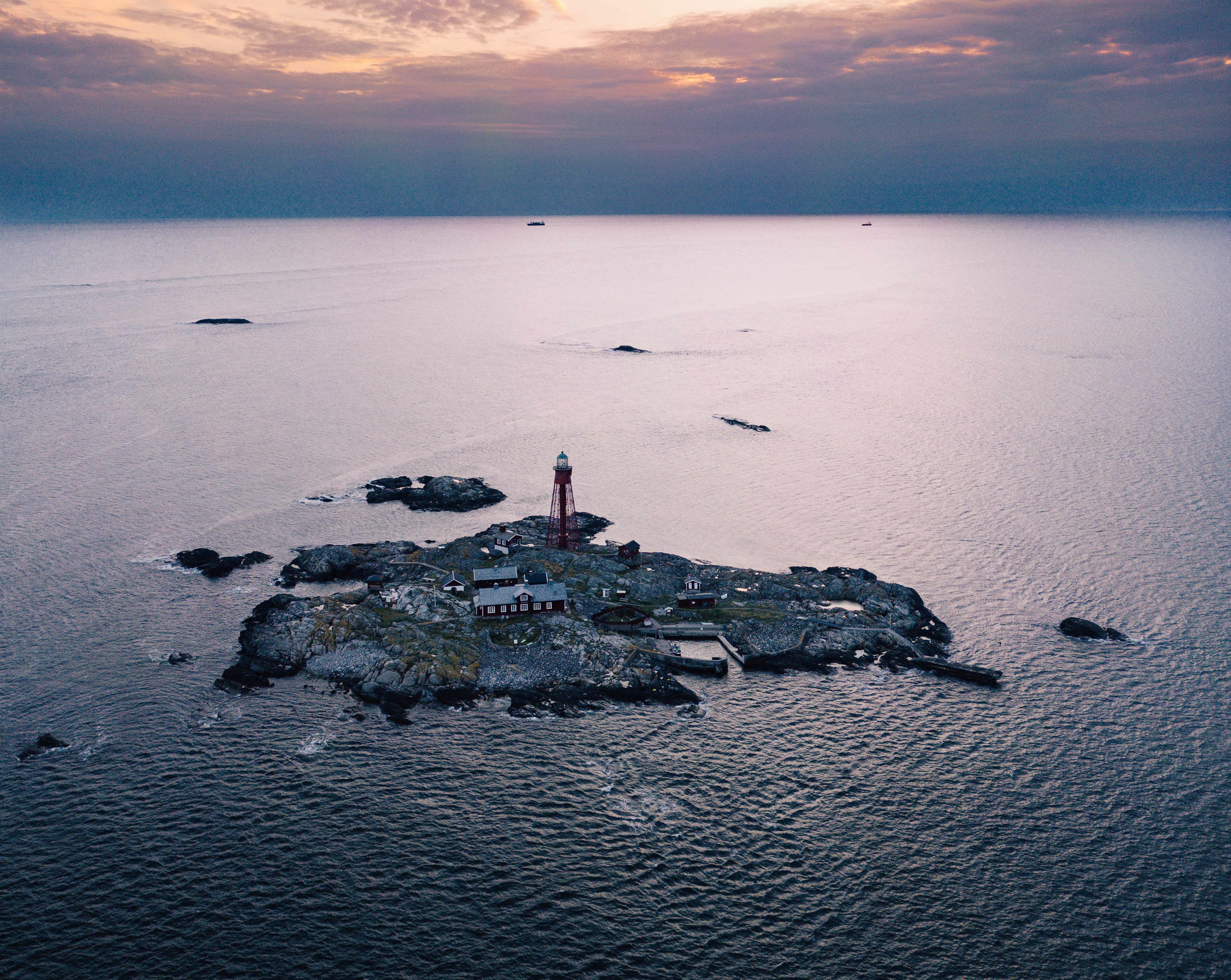 Aerial view over island with a lighthouse.