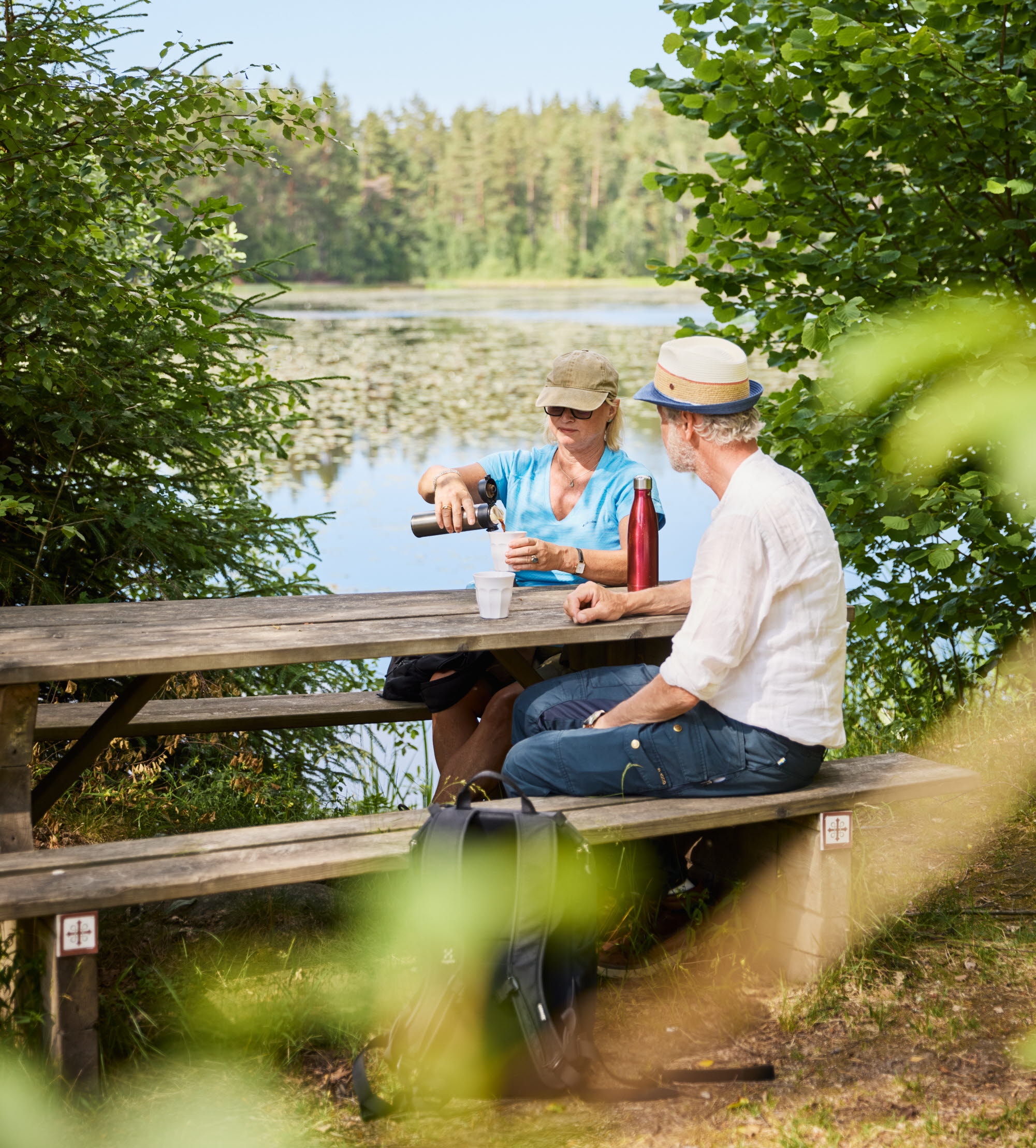 Two people walking in the forest.